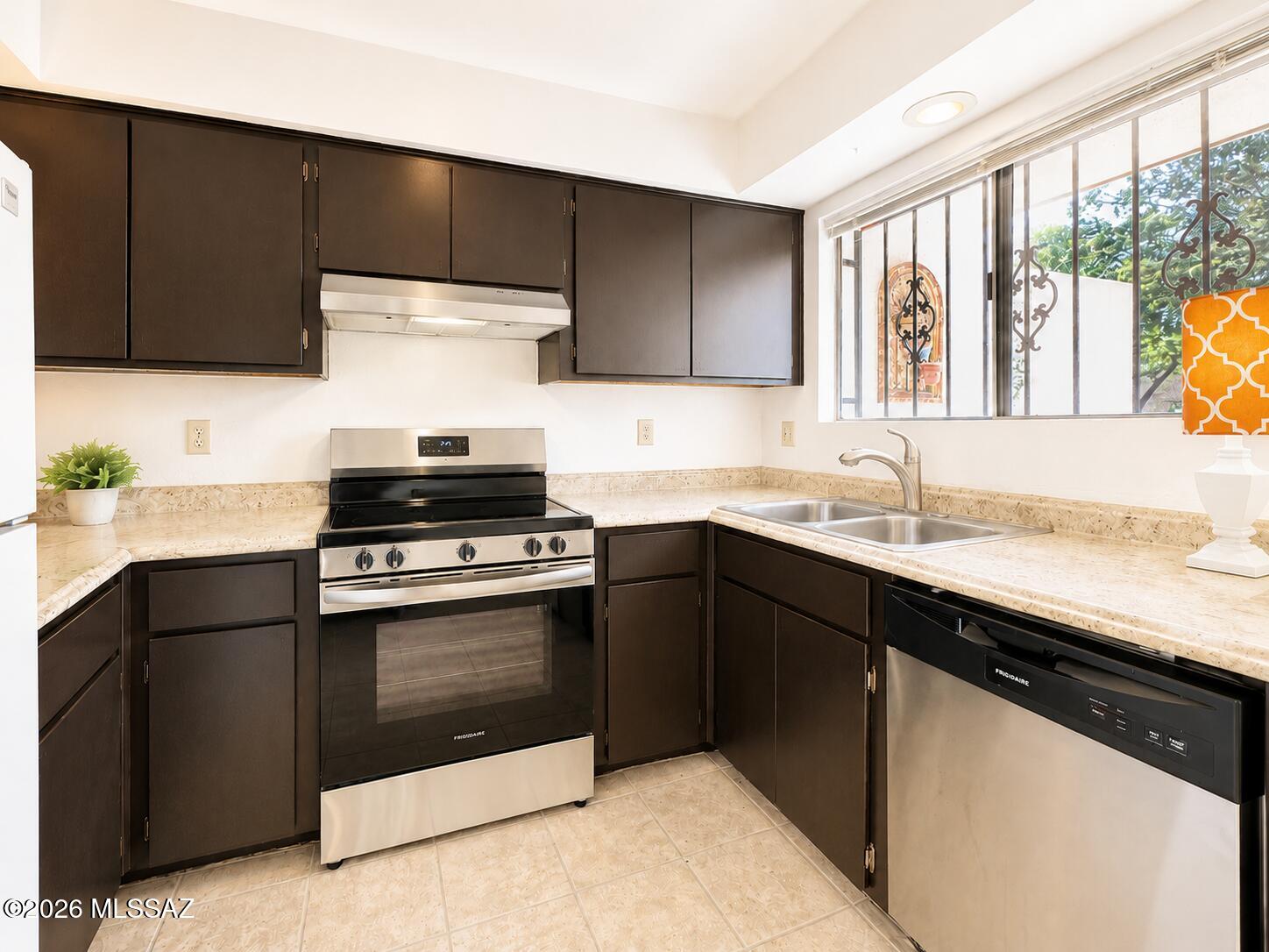 New asphalt, updated kitchen, refreshed bathrooms, and fresh interior and exterior paint! Rental-friendly and ideally located, this move-in ready townhome offers Catalina Foothills views, direct access to The Loop, and walkability to Tucson Racquet Club. The refreshed kitchen features updated cabinetry, newer stove and dishwasher, and a clean, modern feel. HOA covers roof, exterior maintenance, water, sewer, trash/recycle, termite and pest control, and pool. Additional features include vaulted ceilings, tile flooring downstairs, loft-style primary suite, walk-in closet, flexible bonus space ideal for a home office, downstairs bedroom, washer and dryer, covered garage with storage, and flexible rental opportunities. Perfect as a primary residence, seasonal retreat, or investment property!