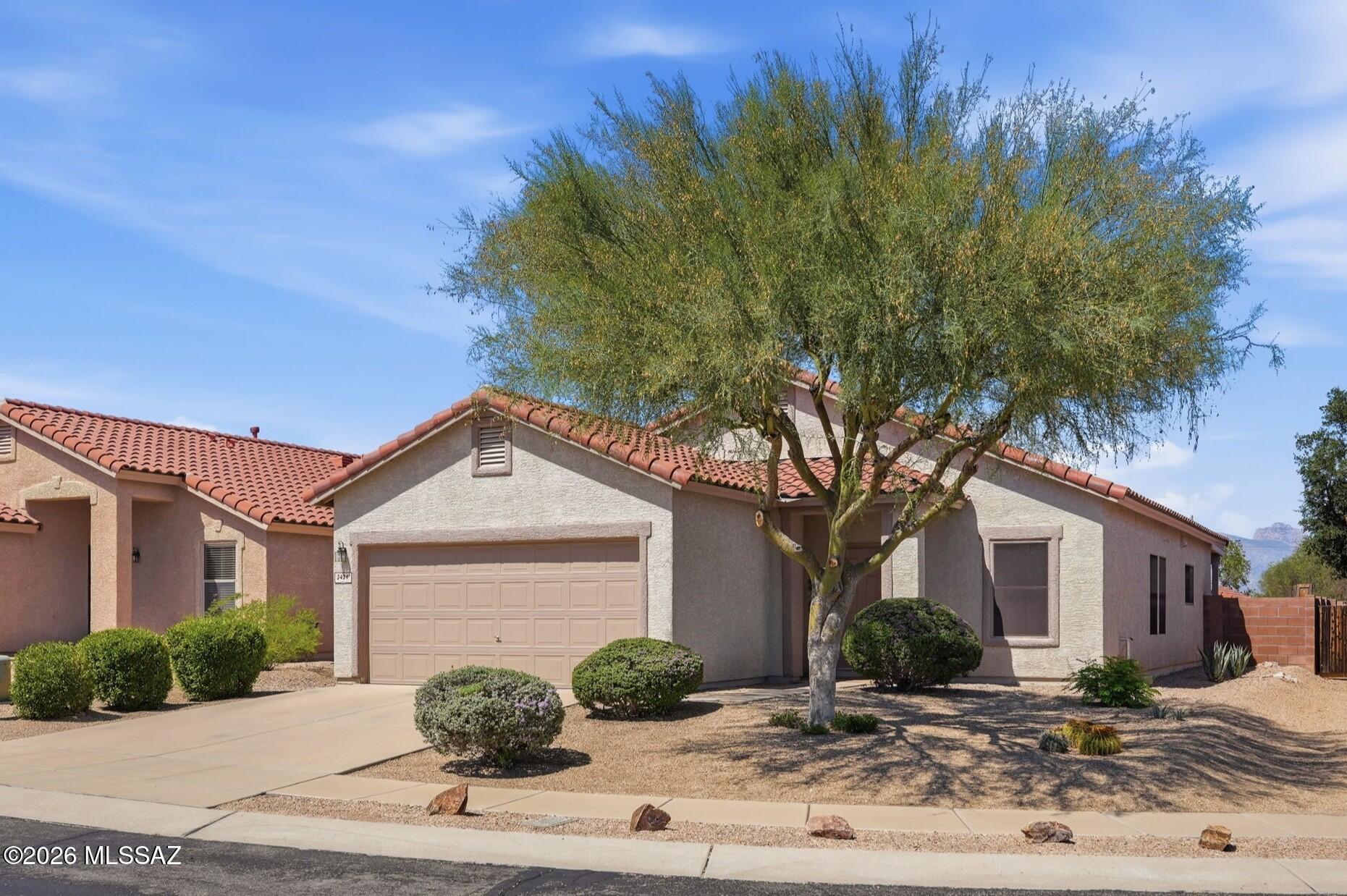 Welcome to 3434 N Oak Springs Ct in gated Sweetwater Reserve, Tucson AZ 85745. This move-in ready single-story home with split floor plan offers 3 bedrooms, 2 baths, and 1,669 sq ft on a premium cul-de-sac lot. Features include upgraded ceiling heights, abundant natural light, porcelain tile flooring, refinished cabinetry, stainless steel kitchen appliances (2020-2024), custom Alta wood blinds, updated bath fixtures including sliding glass shower doors, epoxy garage floor, indoor laundry, and a covered patio overlooking low-maintenance landscaping with artificial turf. Enjoy the community pool, Tucson Mountain views, nearby Sweetwater Preserve trails, Downtown Tucson, the University of Arizona, shopping, dining, golf, and I-10. Welcome to 3434 N Oak Springs Ct, a beautifully maintained single-story home located on a premium cul-de-sac lot within the desirable gated community of Sweetwater Reserve in Tucson's sought-after Northwest side. Offering 3 bedrooms, 2 bathrooms, and 1,669 square feet, this residence reflects years of thoughtful updates and pride of ownership.

The open-concept floor plan features upgraded ceiling heights and abundant natural light, creating a spacious yet comfortable living environment. The kitchen has been refreshed with refinished cabinet fronts, updated hardware, and stainless steel appliances including a Samsung refrigerator (2020) and new range, dishwasher, and microwave (2024). Porcelain tile flooring extends through the kitchen, hallways, and bathrooms, while carpet provides comfort in the bedrooms.

Both bathrooms have been tastefully updated with refinished cabinet fronts, new faucets, updated shower fixtures, decorative mirrors, lighting, and custom tile accents.  Additional interior upgrades include custom Alta wood blinds, ceiling fans, interior paint, and decorative tile detailing in the living area.

The backyard is designed for easy Arizona living with mature desert landscaping, artificial turf installed in 2018, decorative rock, a covered concrete patio and a peaceful outdoor setting ideal for entertaining or relaxing. The epoxy-coated two-car garage offers additional space for storage or ample room for a future workshop, while the indoor laundry room includes washer and dryer hookups.

The home's long history of maintenance includes a new water heater (2016), sliding glass door replacement, exterior trim and eave painting, updated hose bibs, and recent 2025 HVAC service including replacement of the capacitor and Schrader valve.

Residents enjoy the privacy of Sweetwater Reserve along with a community pool, scenic Tucson Mountain views, and convenient access to Sweetwater Preserve hiking and biking trails. Ideally located near Downtown Tucson, the University of Arizona, shopping, dining, golf courses, and I-10, this move-in-ready home offers an exceptional combination of comfort, quality, location, and lasting value.