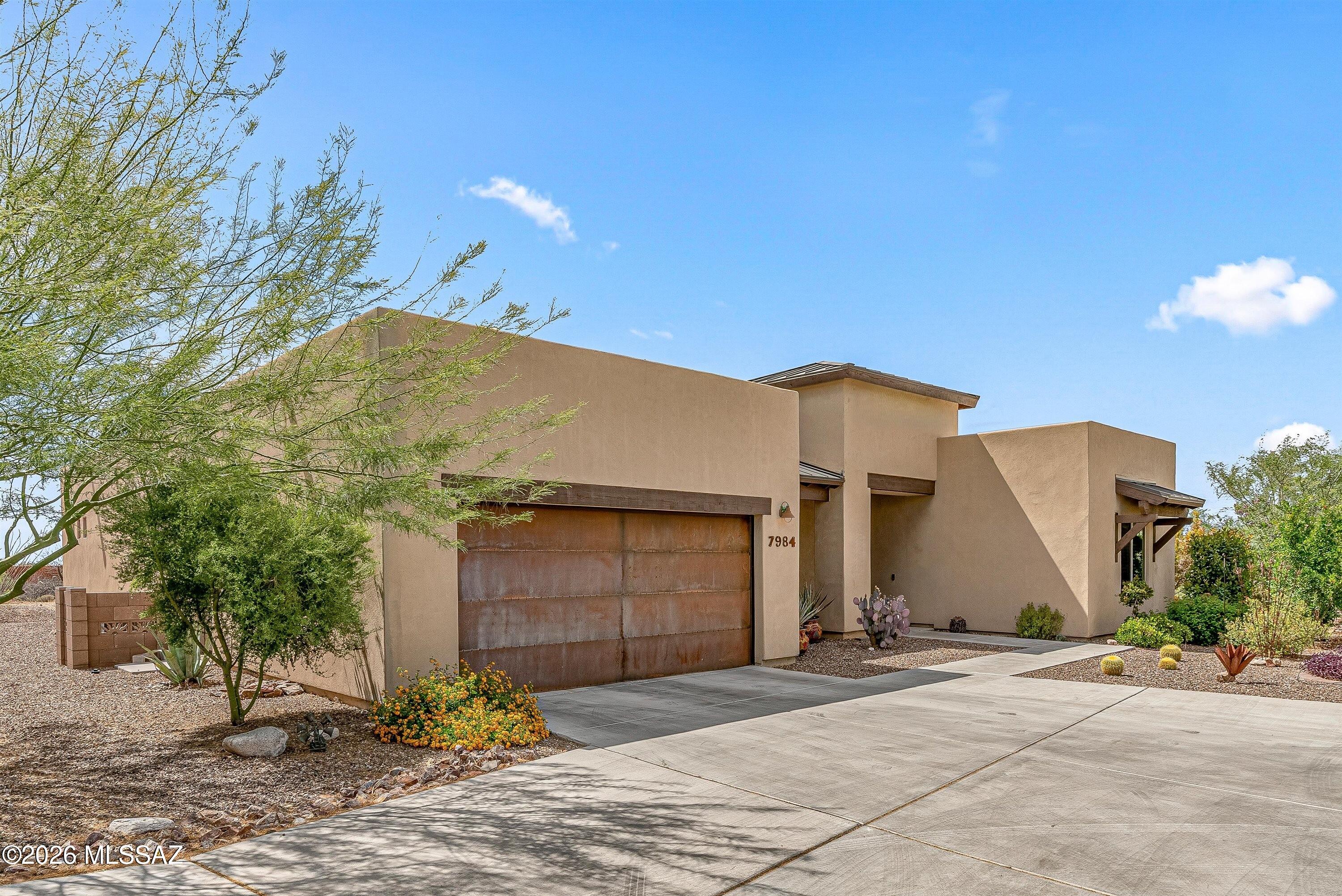 Newer and loaded with premium upgrades. This spacious home features 2 primary bedrooms plus den/office/dining area, all tile floors, and a premium kitchen. Bonus room for dining or office with slider to the patio and a big window for lots of light. Luxury bathrooms with high end fixtures and grab bars, all windows inside have Hunter Douglas automated blinds, plus the back patio has motorized roll shutters for shade and privacy. Extended garage, iron front security door, heavily upgraded lighting for artwork. Outside features a huge patio with pavers that features views of the wash and mountains. Fully landscaped and move in ready! Premium lot overlooks green space, not another home. 55+ community, with outstanding concerts, exercise programs, heated pool and activities to stay connected.