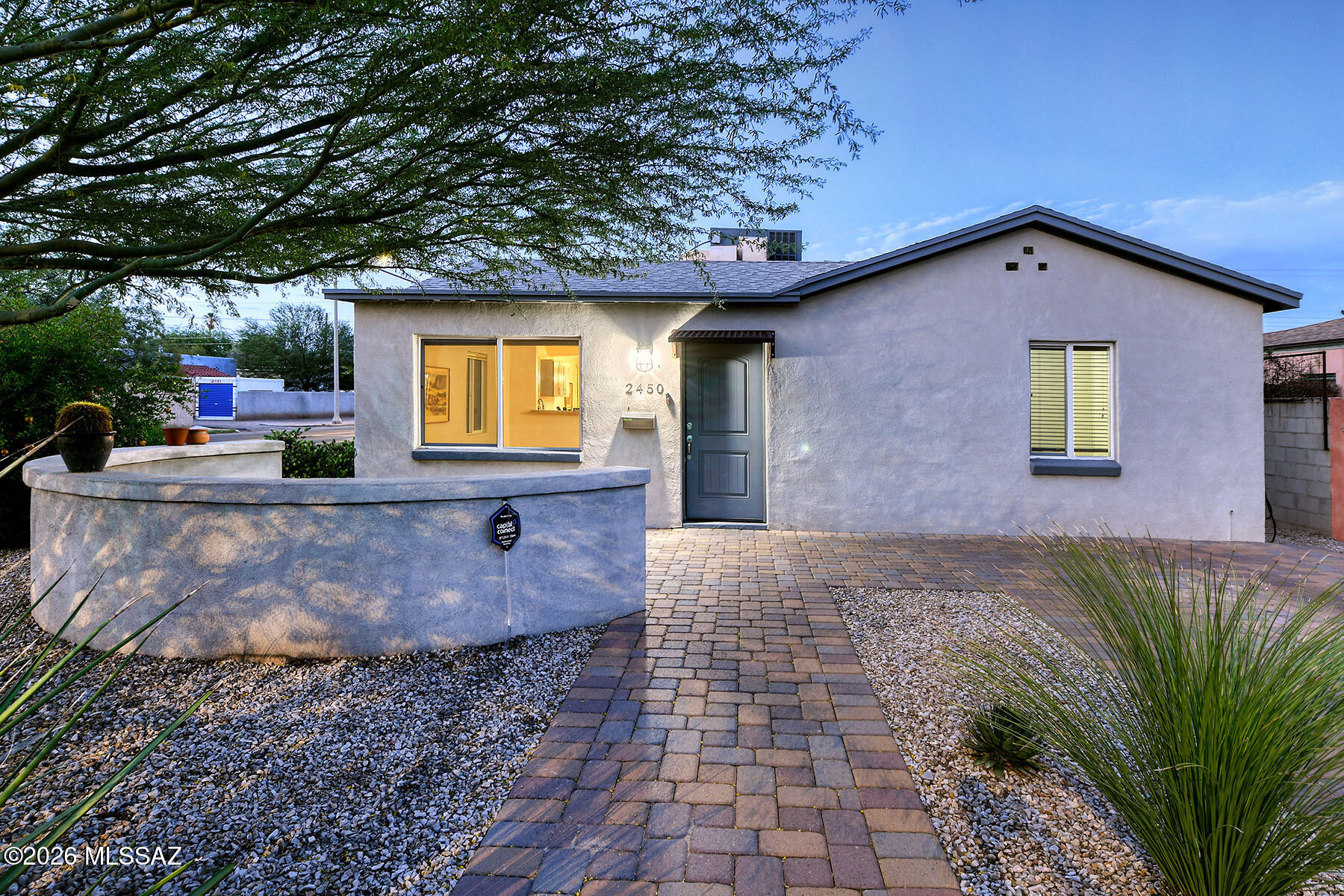 Located along the 3rd Street Bike Path with direct access to the University of Arizona, this beautifully updated and renovated 1948 Sam Hughes bungalow offers the perfect blend of character, comfort, and convenience. Original white oak floors have been carefully restored and are complemented by porcelain tile flooring, wood ceilings, and a spacious great room floor plan. The home also features a separate den and office, providing flexible living and workspaces.
The primary suite includes an ensuite bathroom and walk-in closet. Recent improvements include owned solar and EV charger, newer HVAC systems, new plumbing, and dual-pane windows. The spacious kitchen offers pull-out shelving, stainless steel appliances, and a breakfast bar, creating an inviting space for everyday living and entertaining.
A detached one-bedroom guest house includes a kitchenette and full bathroom, making it ideal for visiting guests, a home office, or potential Airbnb income. The grounds have been thoughtfully landscaped with Belgard multicolored brick, distinctive desert plantings, and mature trees. The private walled backyard provides a peaceful retreat with a firepit, extended garden areas, and shaded outdoor living spaces.
Enjoy one of Tucson's most sought-after historic neighborhoods with easy access to the University of Arizona, Himmel Park, Himmel Park Library, neighborhood restaurants, schools, and more, all just a short walk from your front door.