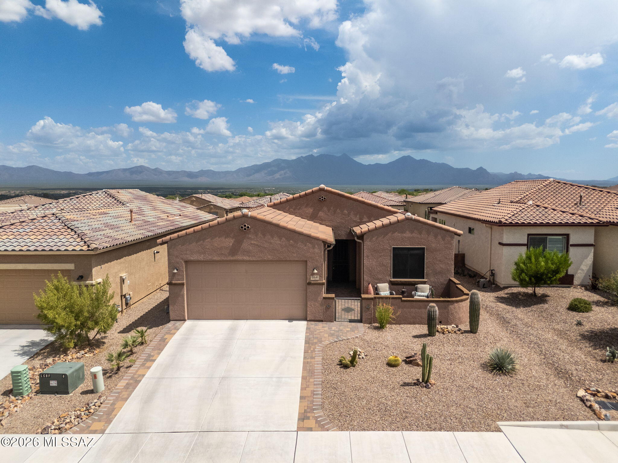 Discover comfortable single-level living at 864 N Camino Cerro Morado in Green Valley's Las Campanas community.  This well-designed home offers approximately 1504 sq ft with an open layout that connects the living, dining, and kitchen areas for easy everyday living and entertaining.  The split-bedroom floor plan provides added privacy, while amazing natural light enhances the inviting interior.  Enjoy the luxury of instant hot water with an on-demand hot water system.  The den can easily be utilized as an office or workout room.  Outside, enjoy low-maintenance desert landscaping and a covered patio with an electric sunshade, creating a relaxing space to unwind or entertain.  Conveniently located near golf, shopping, and dining. This home offers a blend of comfort and Southwest Style.