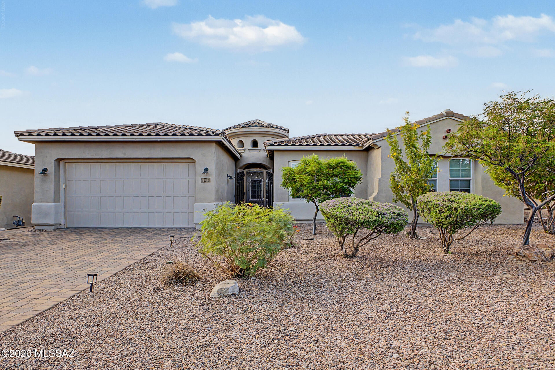 Discover luxury desert living in this stunning 4-bedroom, 4-bath Tortolita model in prestigious Golden Barrel Place at Dove Mountain. A custom iron entry door opens to a beautiful pavered courtyard and an elegant, open-concept floor plan filled with natural light and exceptional upgrades. The gourmet kitchen is a showstopper, featuring a gorgeous wraparound island with built-in seating--perfect for entertaining. A private guest suite and  baths add comfort and sophistication. Step outside to your own resort-style retreat with a sparkling solar-heated pool and north-facing backyard offering breathtaking mountain views. This exceptional home is the perfect blend of luxury, privacy, and effortless indoor-outdoor living! Also,bonus-electric shades give privacy and plenty of shade when needed.