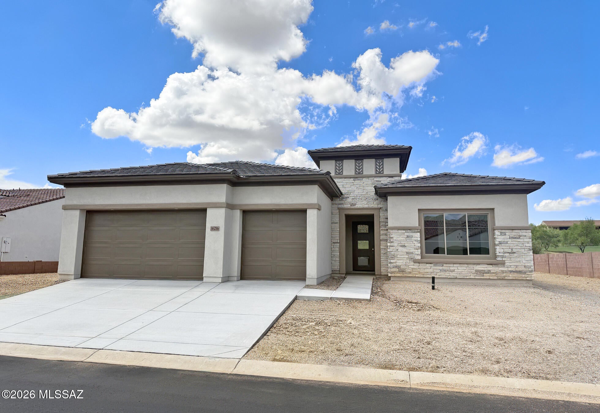 An impeccably designed residence built for refined living. The primary suite features an extended layout with spacious walk-in closet, while the gourmet kitchen showcases custom cabinetry with soft-close drawers, nicely upgraded quartz counters, and a striking scalloped mosaic backsplash. Enjoy a Signature Kitchen Suite appliance package with gas cooktop and built-in wall oven, Delta Kayra fixtures in polished stainless throughout, and designer tile selections in every bath. Interior details include contemporary baseboards, upgraded satin nickel hardware, and premium wide-plank flooring. A sophisticated stucco and drystack stone exterior, extended 3-car garage, and elegant entry door complete this exceptional home. The home's beautifully finished bathrooms feature quartz countertops, coordinating tile surrounds, and quality Kohler Archer elongated comfort-height toilets. Delta Kayra bath fixtures and accessories in stainless steel add a contemporary, polished look, while the powder bath is finished with an elegant Kohler pedestal sink.

Additional upgrades thoughtfully enhance both the home's livability and appeal. The three-car garage has been extended an impressive 4 feet at the front, providing additional flexibility for vehicles, storage, or workspace. The Primary Suite and walk-in closet have each been extended 2 feet, creating an even more spacious private retreat.

Throughout the home, upgraded flooring combines premium carpet, AZ Tile Perla 12" x 24" porcelain tile, and wood/luxury vinyl plank flooring, creating a beautiful blend of style, durability, and easy maintenance. 5" contemporary baseboards add a clean, sophisticated architectural detail throughout.

The laundry room is equally well-appointed, featuring a Sterling Latitude Vikrell utility sink paired with a Delta chrome faucet for added convenience.

Every detail has been carefully selected to elevate everyday living--from the gourmet kitchen and spa-inspired baths to the expanded spaces and premium flooring. This is a home where thoughtful upgrades, timeless finishes, and modern functionality come together beautifully.