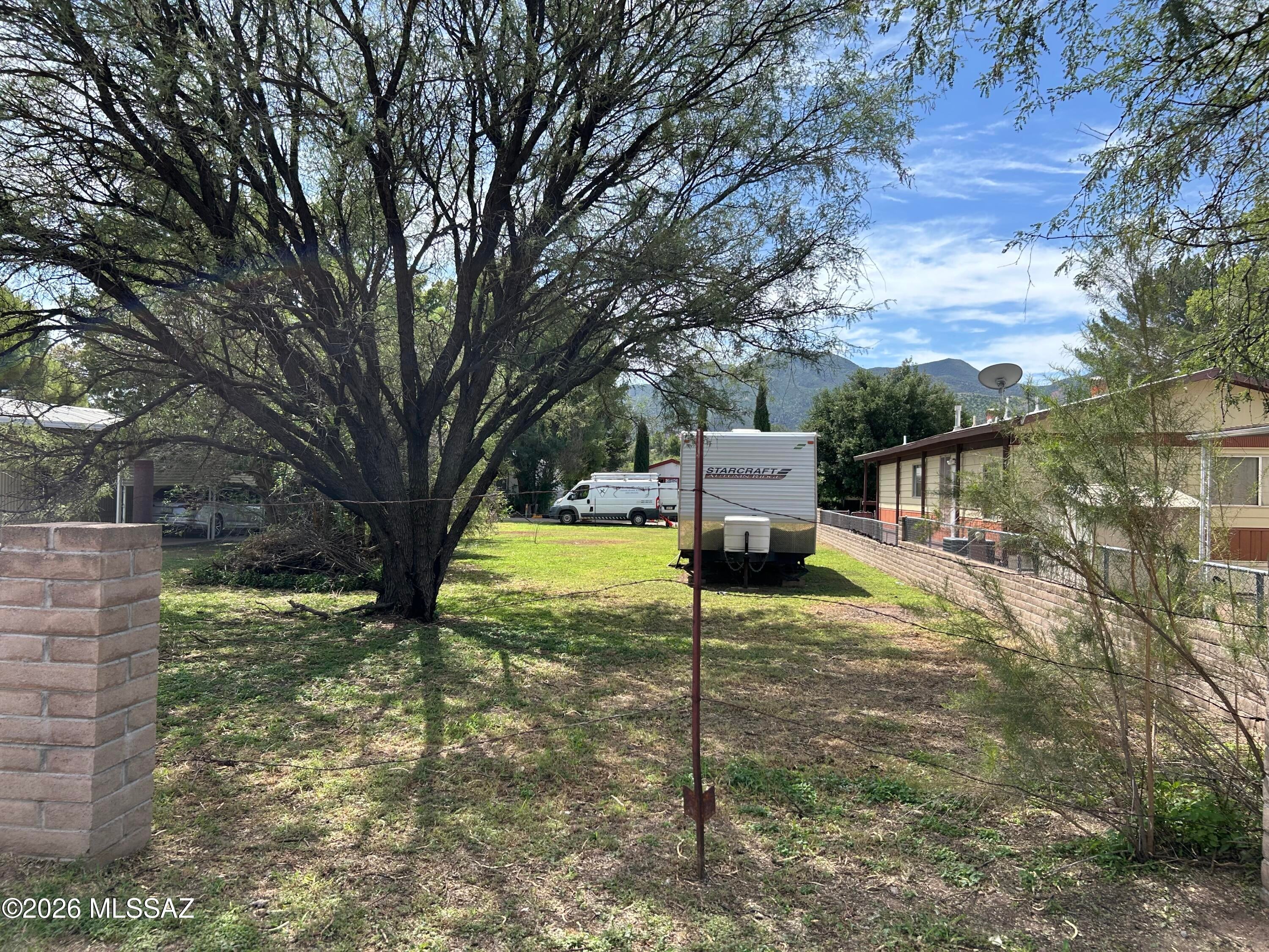 Rare opportunity to own a nice in-town lot complete with Travel Trailer in the well-kept Doubletree Adult Community, a friendly neighborhood of manufactured homes for residents 55+ years of age.  Utilities are available at the lot line.  Lot measures 48 ft by 135 ft -- slightly larger than a typical Patagonia lot.  Perfect for full-time residents or snow-birders.  Great location within walking distance of shops and restaurants.  HOA dues are just $5.00 a year.