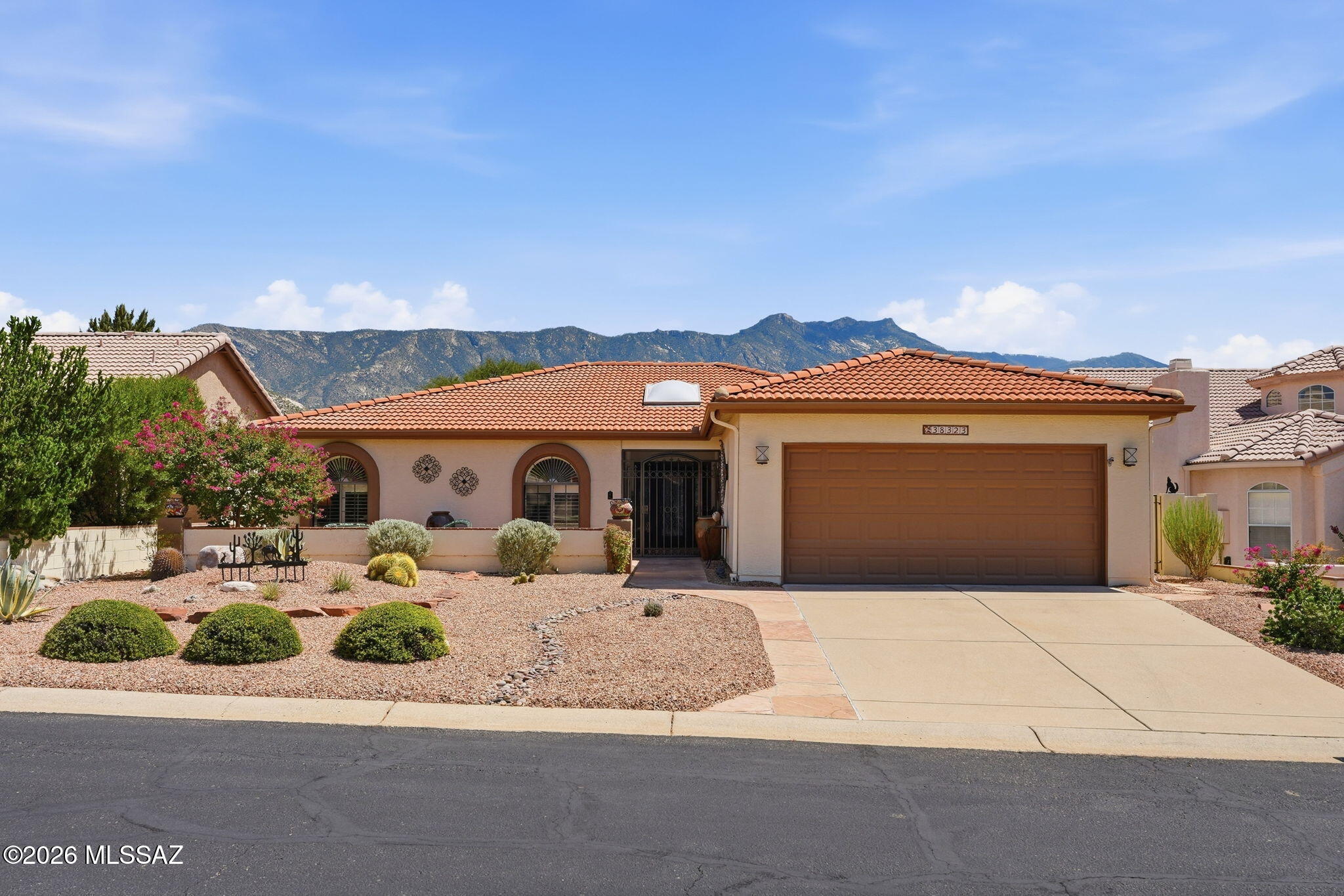 Experience Southern Arizona living and stunning mountain views in this immaculate residence situated inside SaddleBrooke, Southern Arizona's premier 55+ active-adult, golf community. Showcasing the highly expansive Alameda floor plan, this 2BD/2BA+Den/Office (2,026sqft) contemporary home delivers an incredibly functional layout. Designed for upscale entertainment and casual relaxation, the home features fantastic mountain views, a stunning wet bar, and a blend of ceramic tile, and Red Oak wood flooring. The living area serves as a stunning visual anchor, warmed by a gas fireplace. The kitchen acts as a culinary center, complete with a breakfast bar and a flowing layout that connects directly to the dedicated breakfast nook and casual living spaces. The floor plan prioritizes owner privacy, yielding an expansive primary suite with an upgraded bathroom. The home transitions smoothly out to a spectacular, low-maintenance rear oasis situated on a premium lot. The covered patio features classic brick pavers, creating an intimate setting to watch both sunrises and sunsets. Living in Saddlebrooke awards you immediate proximity to elite master-planned amenities. Residents enjoy access to a championship golf club course, tennis and pickleball courts, resort-style swimming pools, state-of-the-art fitness center pavilions, and vibrant social clubhouse dining hubs.