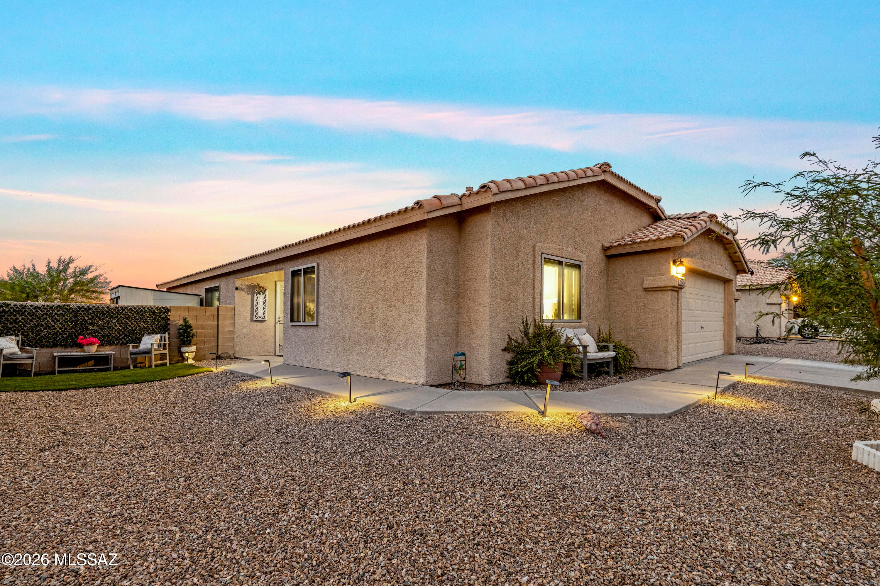 Step inside this inviting Camino Verde Estates II home and discover bright, stylish living spaces, sleek tile, a welcoming kitchen and dining area, a relaxing primary retreat, and flexible space with possibilities. Outside, the story gets even better with a covered patio, low-maintenance landscaping, and illuminated gazebo and pergola areas designed for memorable Arizona evenings.
Located on Tucson's west side, Camino Verde Estates II offers access to the scenery and recreation that make Southern Arizona distinctive. Explore Tucson Mountain Park, Saguaro National Park West, the Arizona-Sonora Desert Museum, plus downtown Tucson dining, shopping, culture, and entertainment.
The photos are only the beginning. Schedule your private showing and discover this Tucson home in person!