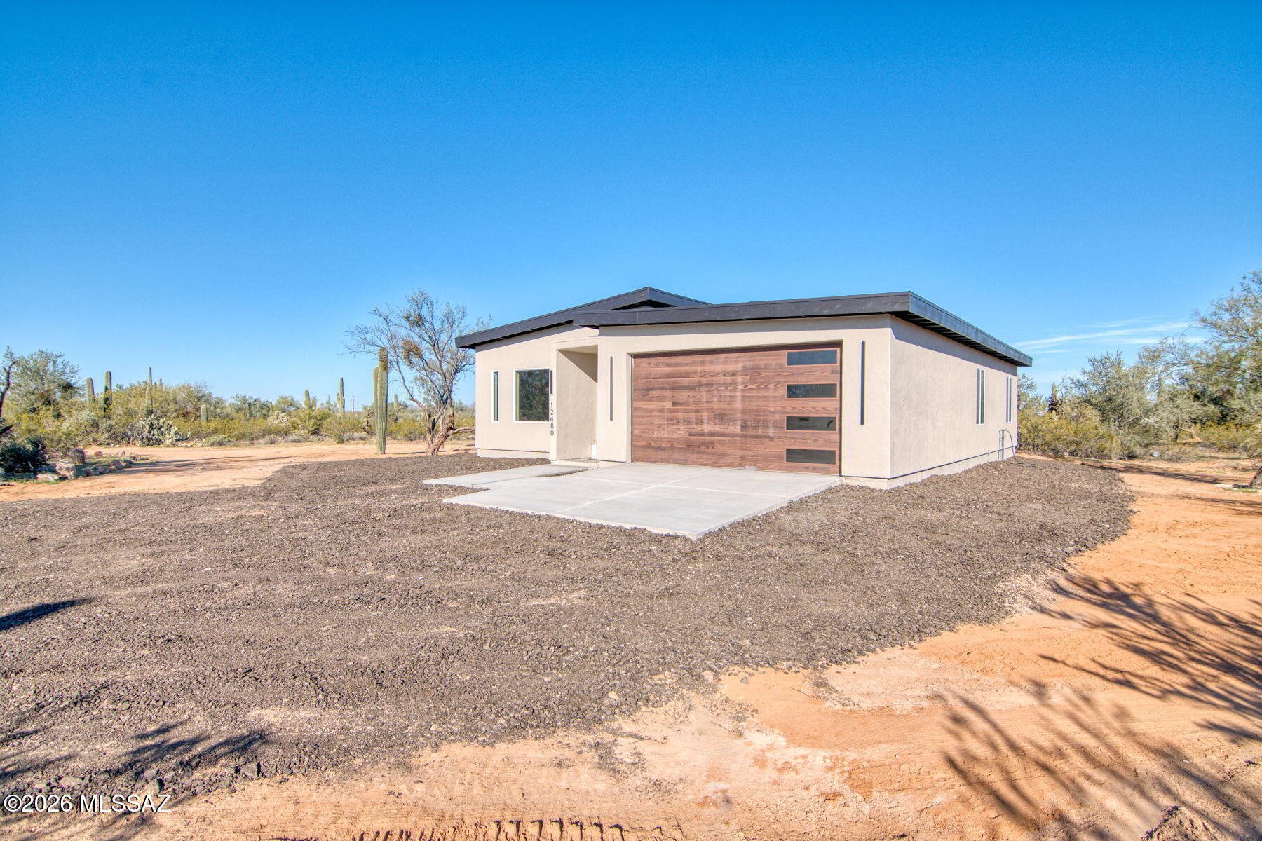 Welcome to this exceptional custom home, thoughtfully designed with modern luxury and breathtaking desert surroundings. This 3-bedroom, 2-bath residence features a spacious 2-car garage and showcases high-end finishes throughout.

The gourmet kitchen is a true showstopper, offering oak shaker cabinetry, marbled quartz countertops, a dramatic waterfall island, and a walk-in pantry with added storage--perfect for both everyday living and entertaining. Black double doors open to mesmerizing sunset views, seamlessly connecting the interior to the serene desert landscape and mountain backdrop.

The open-concept living area is anchored by a striking floor-to-ceiling electric fireplace, complemented by sleek black tile flooring, while plush carpeted bedrooms provide comfort and warmth The primary suite is a private retreat, featuring a fitted closet system, floating sinks, a spa-like bathroom with a rain shower, tile-surround shower, Deer Valley toilets, a touchscreen LED bathroom mirror, and modern doors throughout the home.

Additional highlights include custom light fixtures, black hardware finishes, contemporary design elements, and refined attention to detail in every space.

Situated on a generous .99-acre lot, this property offers endless possibilitiesroom to create, expand, and truly make it your own, all while enjoying the beauty of desert living and expansive mountain views.