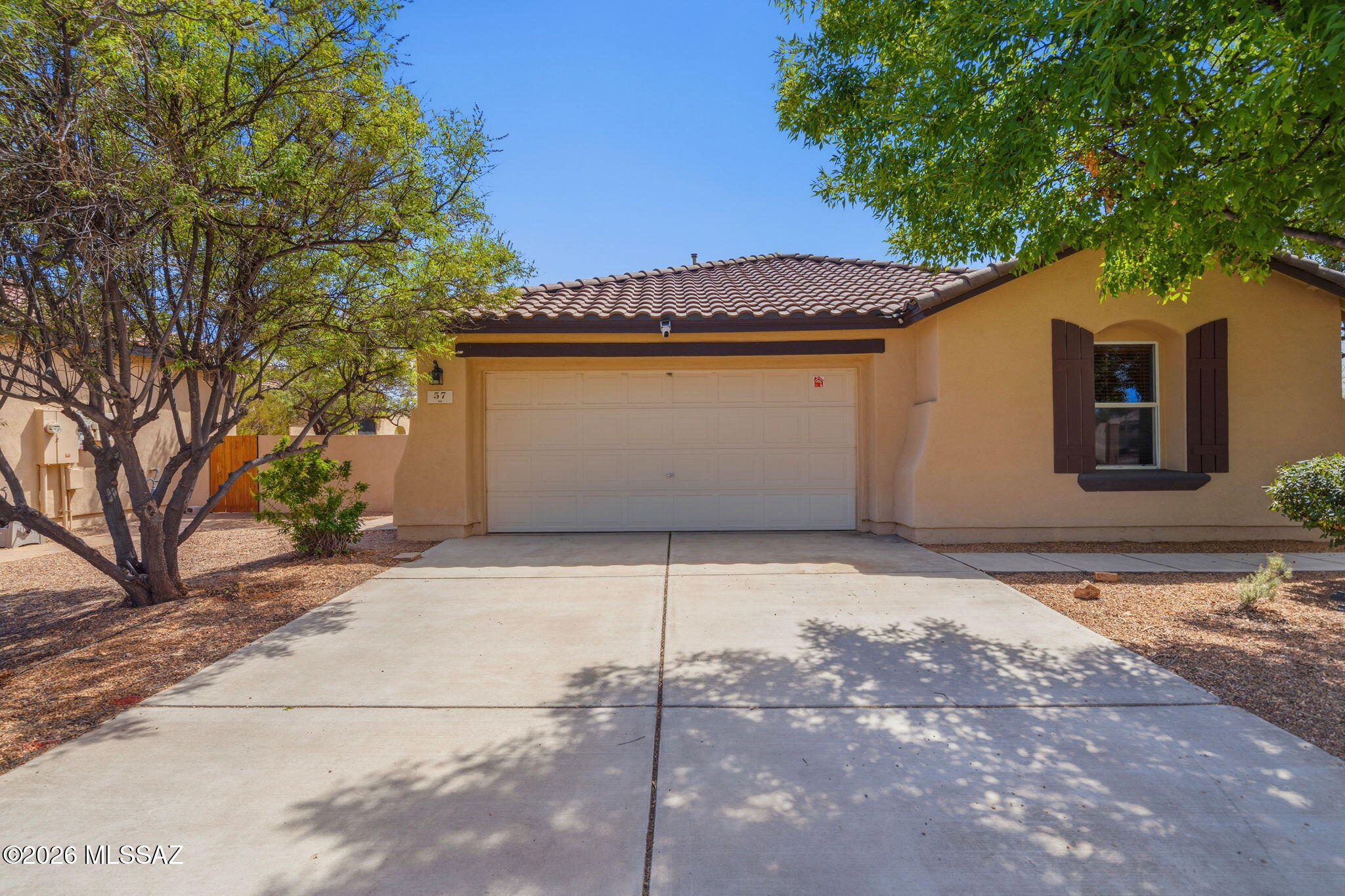 ASSUMABLE 2.75% VA LOAN WITH APPROXIMATELY $175,000 REMAINING BALANCE + PAID-OFF SOLAR! An incredible opportunity in sought-after Rancho Sahuarita! This beautifully maintained 4-bedroom, 2-bath home offers 1,861 sq. ft. of comfortable living on a desirable corner lot with no rear neighbors and added privacy! Enjoy peace of mind with a newer AC, water heater, and updated appliances, plus the savings of fully paid-off solar! The inviting open-concept kitchen and great room feature cherry cabinetry, granite countertops, a spacious island, and tile and wood flooring throughout. A versatile den with French doors offers the perfect space for a home office or flex room. Step outside to your own backyard retreat featuring mature trees, an extended covered patio, built-in seating, a newer gazebo, and beautiful natural desert views.  Enjoy Rancho Sahuarita's resort-style amenities, including pools, a water park, fitness center, parks, and more!  PRIVACY, ENERGY, SAVINGS, AND MAJOR UPDATES - THIS HOME checks all of the boxes.