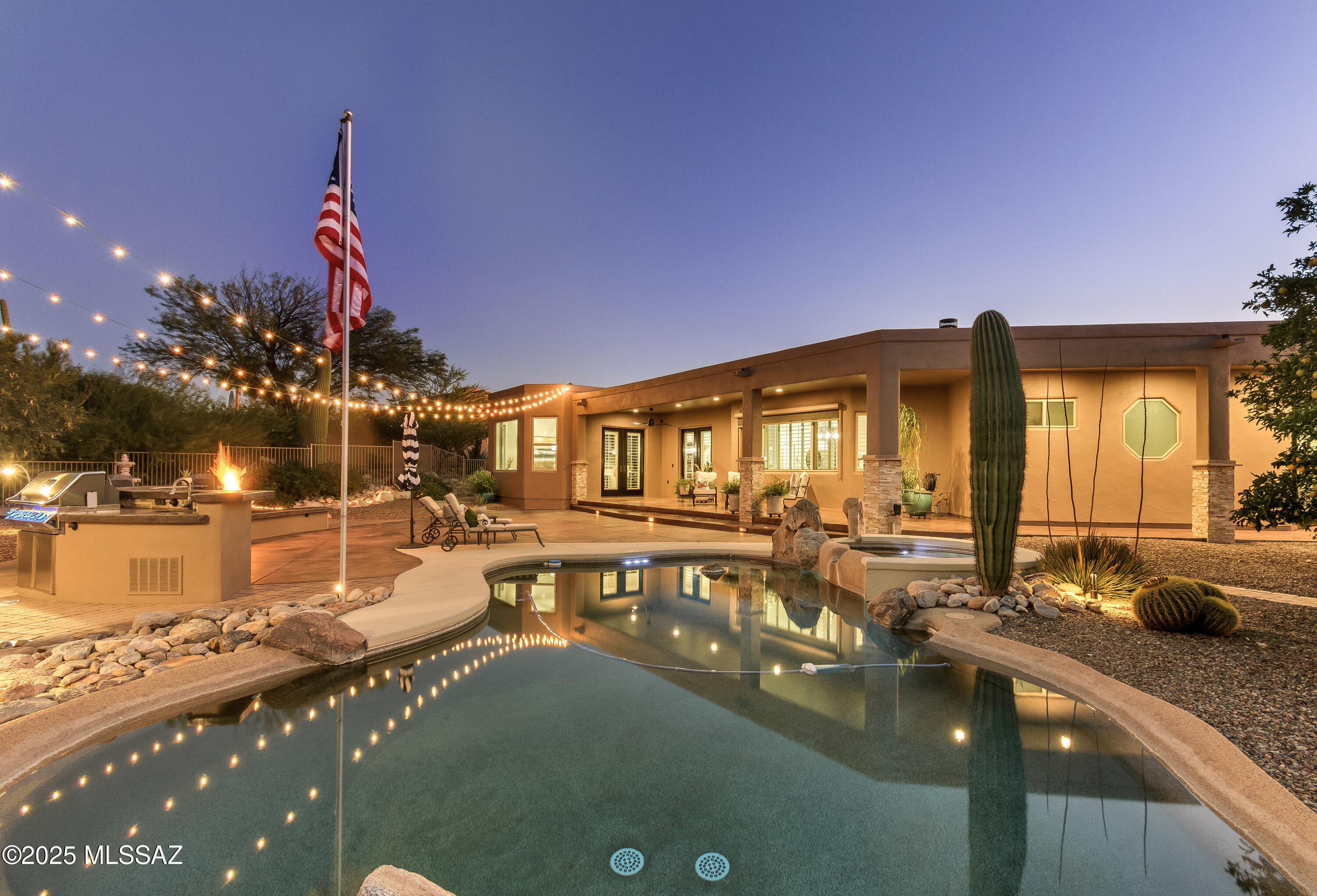 This Catalina Foothills masterpiece is located on a peaceful Shadow Hills cul-de-sac. The home offers  4 bed, 3 bath and over 3,000 sq ft of living space on nearly 1 acre with sweeping mountain views. The open floor plan features soaring ceilings, a cozy fireplace, a gourmet kitchen with granite counters, custom cabinets, and professional-grade appliances. Enjoy a spacious pantry and wine storage area. The primary suite opens to a private backyard retreat with a Pebble Tec pool, spa, outdoor kitchen, and ramada—all surrounded by lush desert landscaping. A true foothills gem.