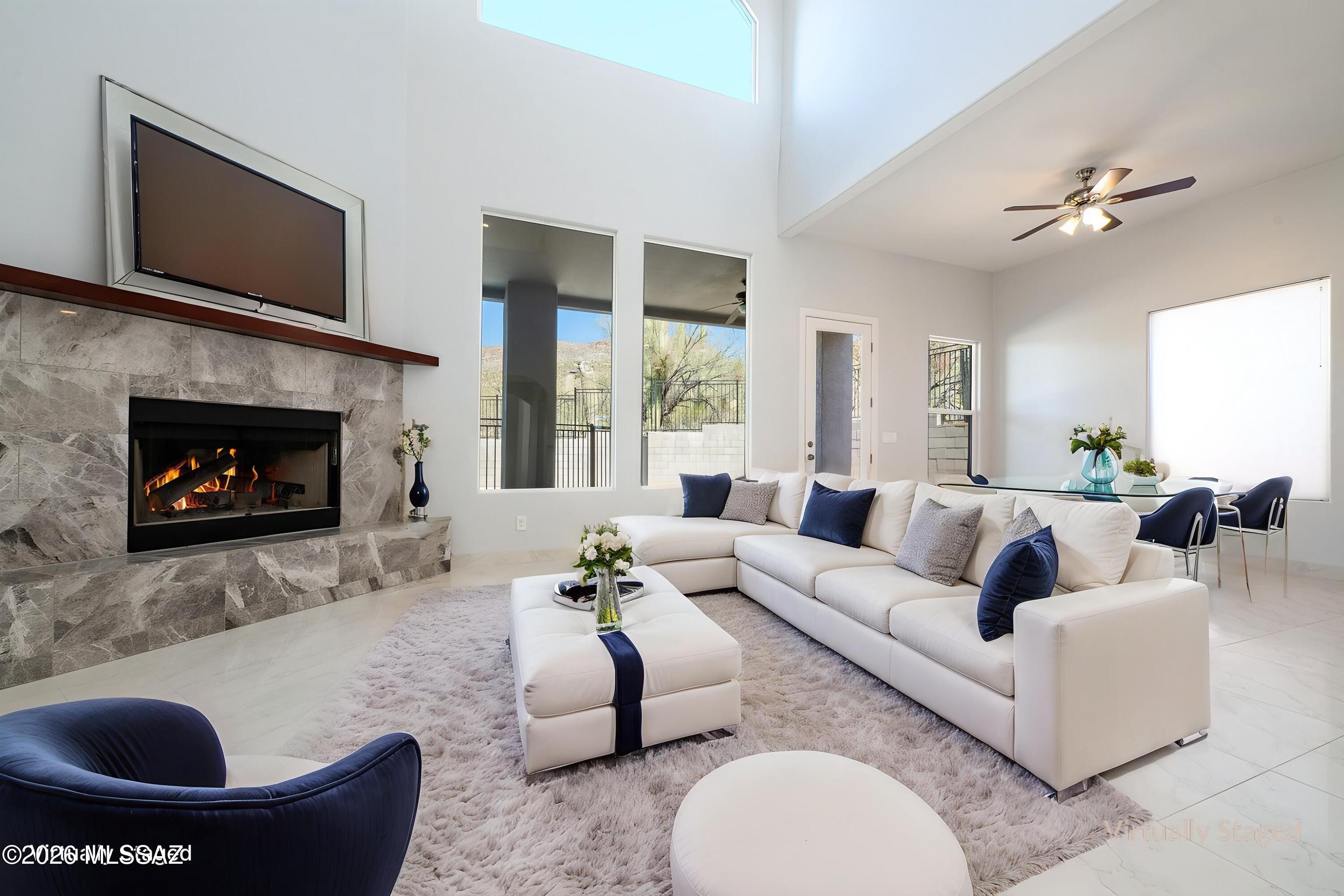 Experience refined living at the base of the Catalina Mountains in this stunning custom two-story estate, privately situated on nearly one acre behind a long, gated drive. Designed with both elegance and comfort in mind, this 4-bedroom, 4-bath residence showcases soaring 12-foot ceilings throughout, with a dramatic 24-foot ceiling in the grand entry and family room that creates an unforgettable first impression.The thoughtfully designed floor plan offers a seamless flow between the formal dining room, den/playroom, and expansive great room featuring a beautiful fireplace. The gourmet kitchen is appointed with custom wood cabinetry, generous workspace, and a spacious walk-in pantry--perfect for both everyday living and entertaining. The luxurious primary suite is a true retreat, complete with a private upstairs balcony capturing city and mountain views. The spa-inspired primary bath boasts marble flooring, a marble walk-in steam shower, double sinks, a vanity area, and separate his-and-her closets for ultimate convenience.Upstairs, you'll find a well-placed laundry room and additional balcony access. Three guest bedrooms offer exceptional comfort, including a Jack-and-Jill bath and an additional bedroom with its own private bath.Step outside to your private backyard oasis featuring a large patio, fenced pool, and low-maintenance turf--ideal for relaxing or hosting gatherings year-round.
With its impressive scale, high-end finishes, and resort-style amenities, this estate offers luxury living at its finest.
Seller is a licensed Real Estate Agent.