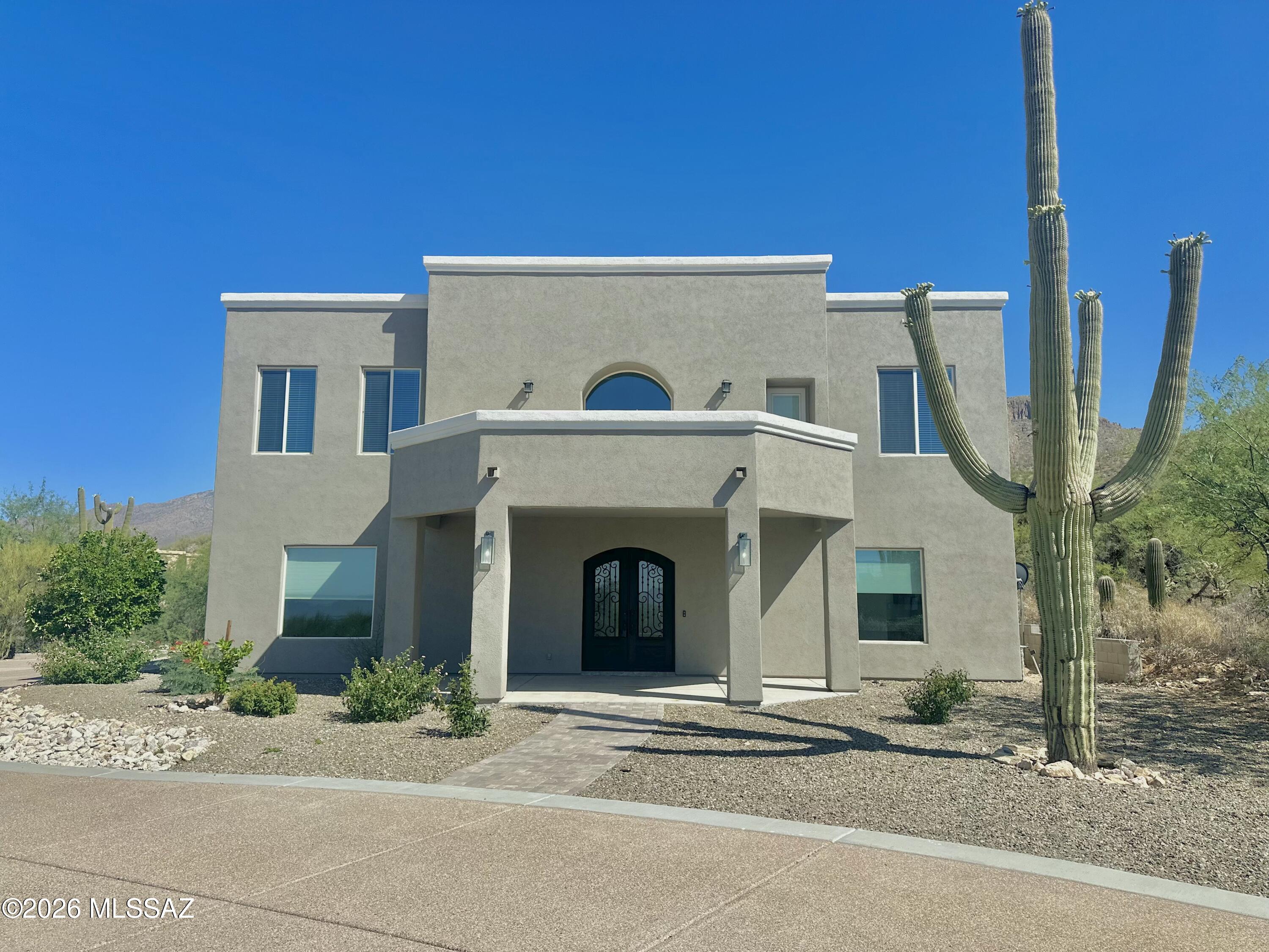 Experience refined living at the base of the Catalina Mountains in this stunning custom two-story estate, privately situated on nearly one acre behind a long, gated drive. Designed with both elegance and comfort in mind, this 4-bedroom, 4-bath residence showcases soaring 12-foot ceilings throughout, with a dramatic 24-foot ceiling in the grand entry and family room that creates an unforgettable first impression.The thoughtfully designed floor plan offers a seamless flow between the formal dining room, den/playroom, and expansive great room featuring a beautiful fireplace. The gourmet kitchen is appointed with custom wood cabinetry, generous workspace, and a spacious walk-in pantry--perfect for both everyday living and entertaining. The luxurious primary suite is a true retreat, complete with a private upstairs balcony capturing city and mountain views. The spa-inspired primary bath boasts marble flooring, a marble walk-in steam shower, double sinks, a vanity area, and separate his-and-her closets for ultimate convenience.Upstairs, you'll find a well-placed laundry room and additional balcony access. Three guest bedrooms offer exceptional comfort, including a Jack-and-Jill bath and an additional bedroom with its own private bath.Step outside to your private backyard oasis featuring a large patio, fenced pool, and low-maintenance turf--ideal for relaxing or hosting gatherings year-round.
With its impressive scale, high-end finishes, and resort-style amenities, this estate offers luxury living at its finest.
Seller is a licensed Real Estate Agent.