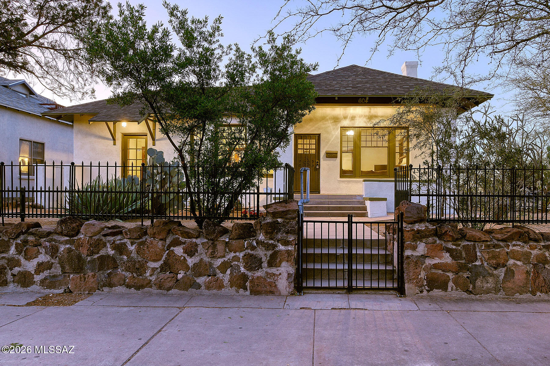 Beautifully situated in the heart of the West University Historic District, this Arts and Crafts bungalow blends timeless character with thoughtful modern updates. Massive R2 Lot with room to build!  The home was built in 1900, and has been carefully enhanced while preserving its original charm, offering both historic appeal and contemporary comfort. Recent improvements include a new roof installed in 2025, a new 4-ton 15 SEER gas pack added in December 2025, and a new gas water heater, providing peace of mind for years to come. The interior and exterior were freshly painted in December 2025, and a upgraded 125-amp electrical service and new electrical fixtures and ceiling fans throughout the home. The rear siding was removed and replaced with added insulation and new stucco, improving both efficiency and durability.
The primary and guest bathrooms have been completely remodeled with new cabinetry, custom tilework, updated lighting, plumbing fixtures, mirrors, and accessories, creating spaces that feel both elegant and inviting. Original hardwood floors have been beautifully refinished, while new bamboo flooring enhances the fourth bedroom and hallway, and large-format luxury vinyl flooring adds style and functionality to the kitchen. GFCI outlets have been installed in all wet areas, along with new smoke and carbon monoxide detectors for added safety.
Outside, the front yard has been professionally landscaped to enhance the home's curb appeal, and the property is protected by a termite warranty policy. This exceptional bungalow offers a rare opportunity to own a meticulously updated historic home in one of Tucson's most desirable neighborhoods.