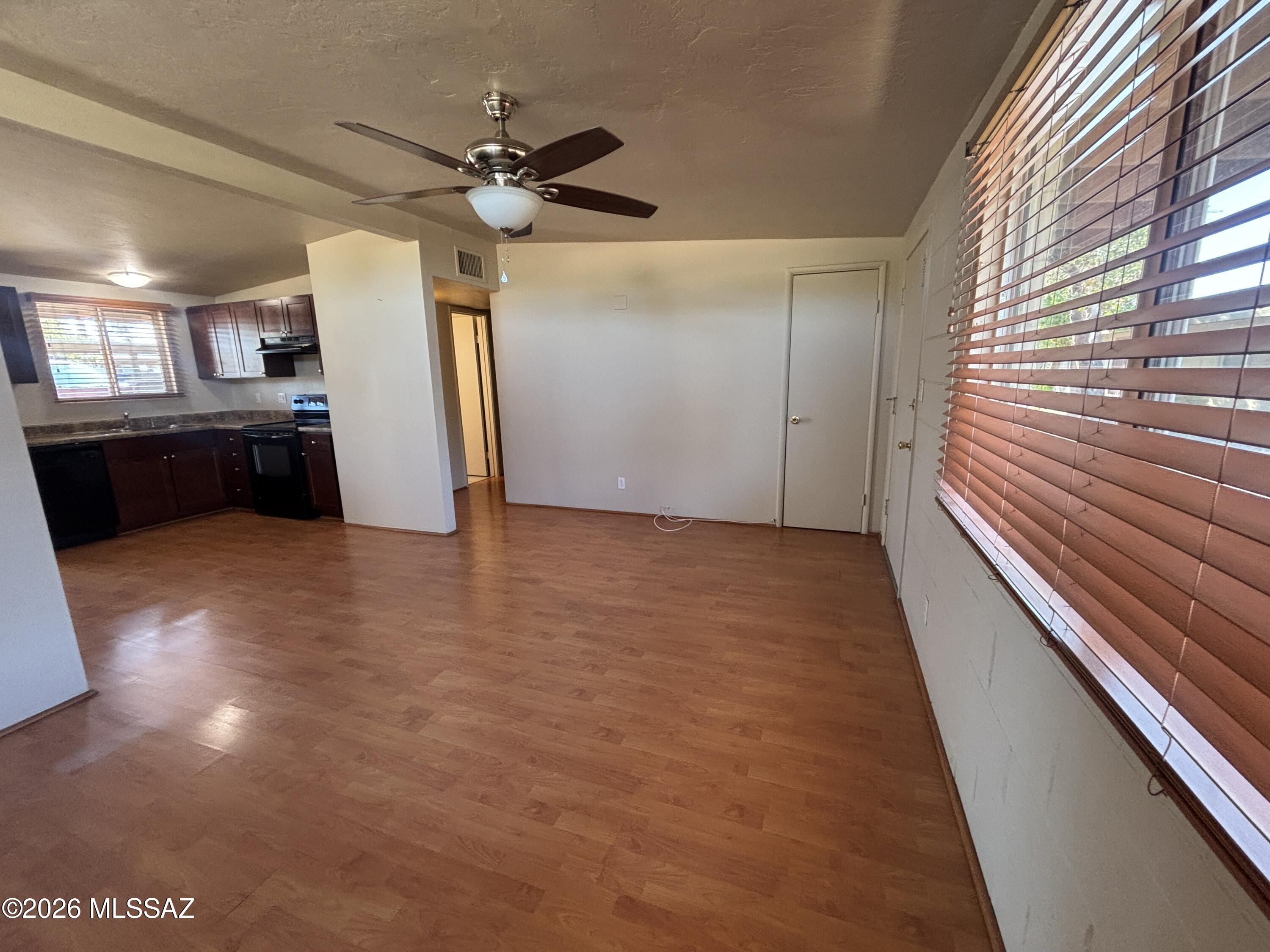 Charming 2 bedroom, 1 bath unit features beautiful and durable flooring throughout. The kitchen opens up to the living room, bringing in plenty of natural light. This home offers two generous bedrooms, washer and dryer hook-ups, a private patio, and access to the community pool. Its central location provides easy access to emergency services, restaurants, and more.