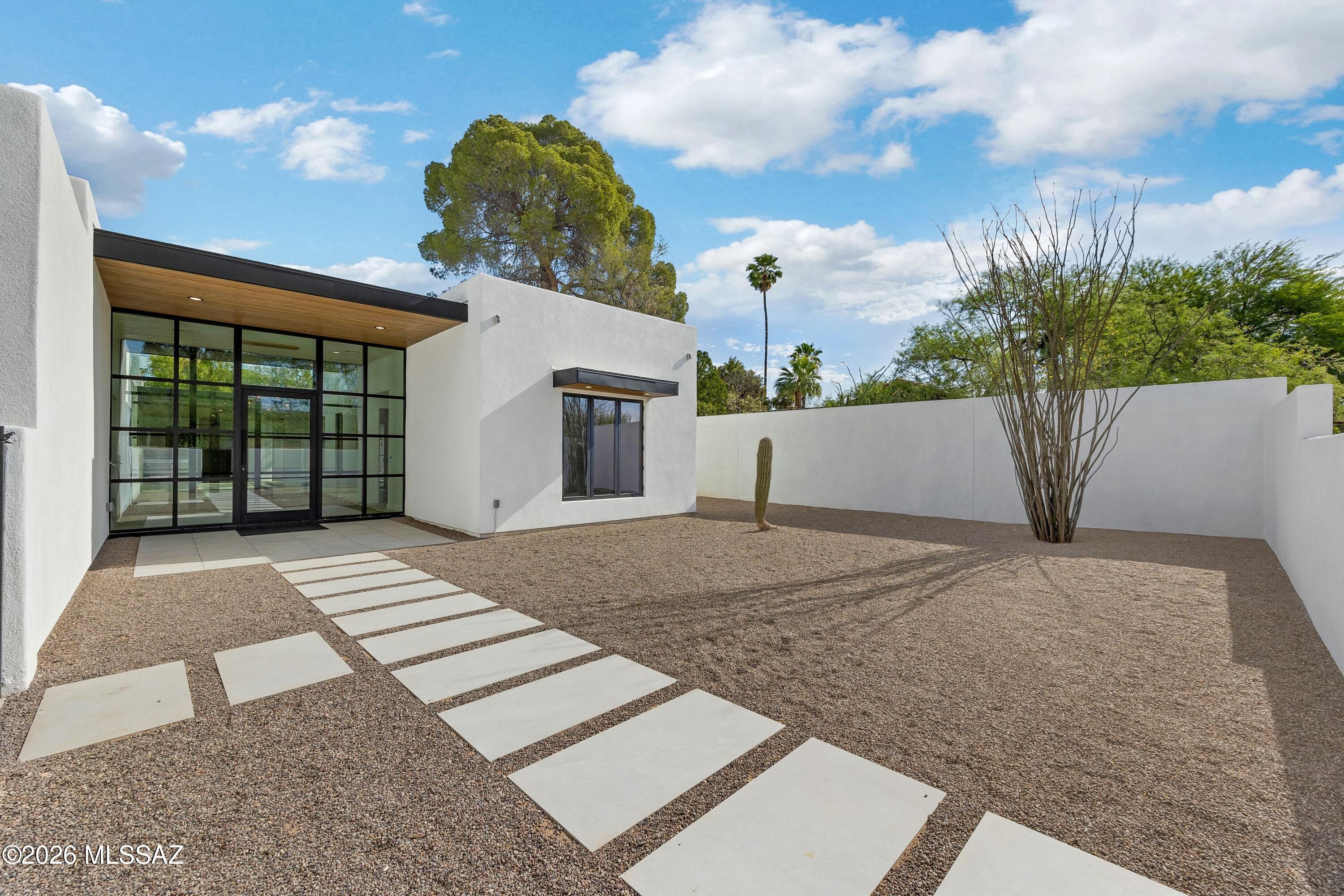 Looking for your quiet dream home this is it. This custom home, built in El Montevideo is one of Tucson's most charming historic neighborhoods, know for its strong sense of community and highly walkable lifestyle brings neighbors together and welcomes new residents to this growing area. This contemporary home was designed by Tucson architect Karen Bellamy and built by custom builder Robin Hartman Hartman Construction. This stunning clean line single story 3614 SF home features 4 BD + 1 Office, 5 BA w/ fully equipped guest house.  Home features  12+ ceilings, 800 SF covered pool patio and is prewired w/ CAT 6 throughout, outdoor for private daytime play and relaxed evenings. The home was designed with exceptional detail in every room, all of which are detailed in the documents tab.