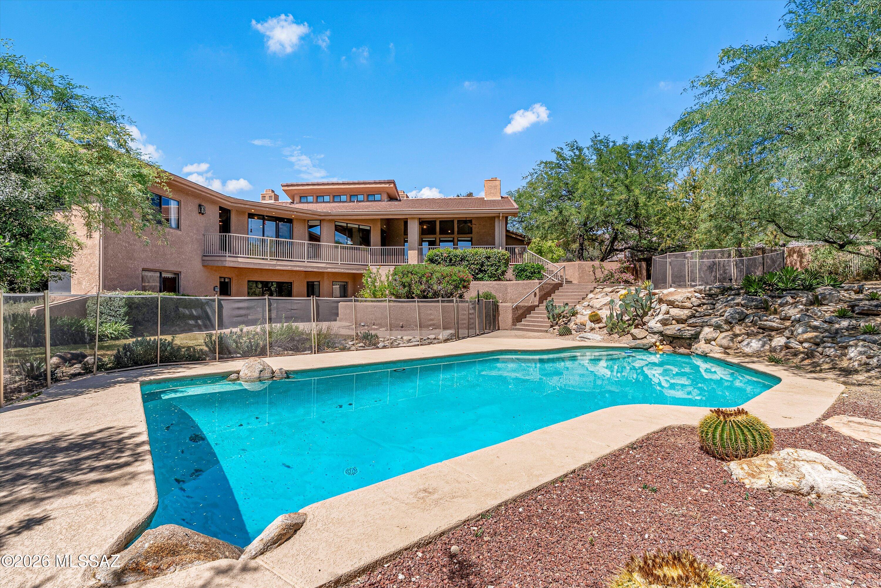 Experience luxury living in this stunning 5500 sq ft residence designed for both comfort  and entertaining. The expansive floor plan offers generous living spaces filed with natural light & high ceilings. The floor plan is versatile and inviting. The main level holds 3 bedrooms plus an office and living areas, while the lower level encompasses 3 additional bedrooms, full bath and an abundance of storage areas. Step outside to a truly exceptional backyard oasis featuring a sparkling pool & spa, perfect for relaxing or hosting unforgettable gatherings. Take in the breathtaking mountain views that create a serene and picturesque setting. This home blends indoor elegance with outdoor beauty, offering the ultimate retreat for those who appreciate space, privacy and spectacular surroundings.