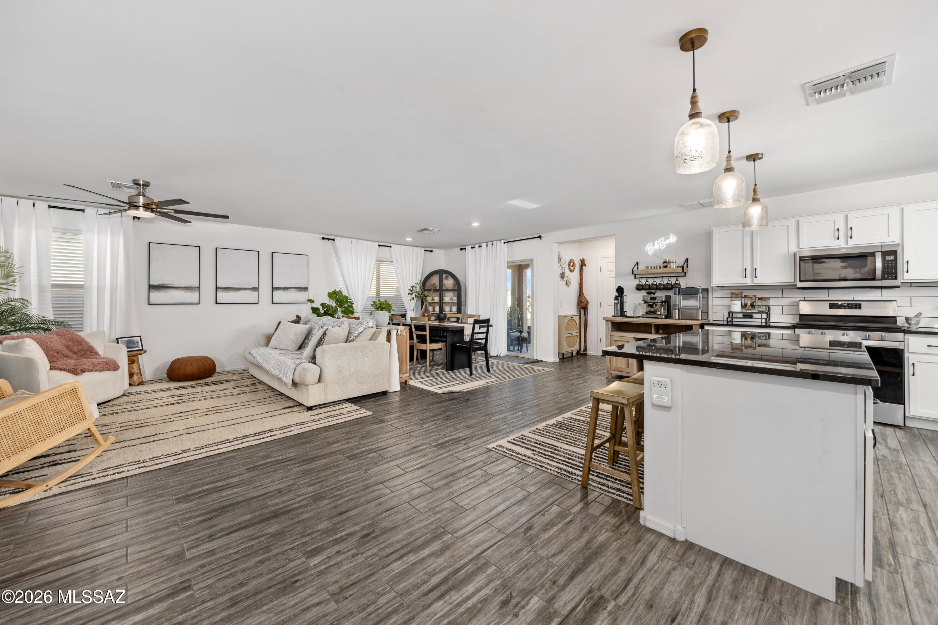 Beautifully maintained single-story home in the sought-after Rancho Sahuarita community! This 3 bedroom, 2 bathroom home offers privacy with no rear neighbors and scenic desert trail views out front. Inside, you'll find granite countertops, an open-concept layout, a versatile den ideal for a home office or flex space, and no carpet throughout. The home also features a radiant barrier roof for improved energy efficiency. The spacious backyard offers endless potential for entertaining or relaxing. Located minutes from Sahuarita Lake and the Rancho Sahuarita Clubhouse with access to pools, water slides, parks, tennis courts, walking trails, fitness amenities, and year-round community events.