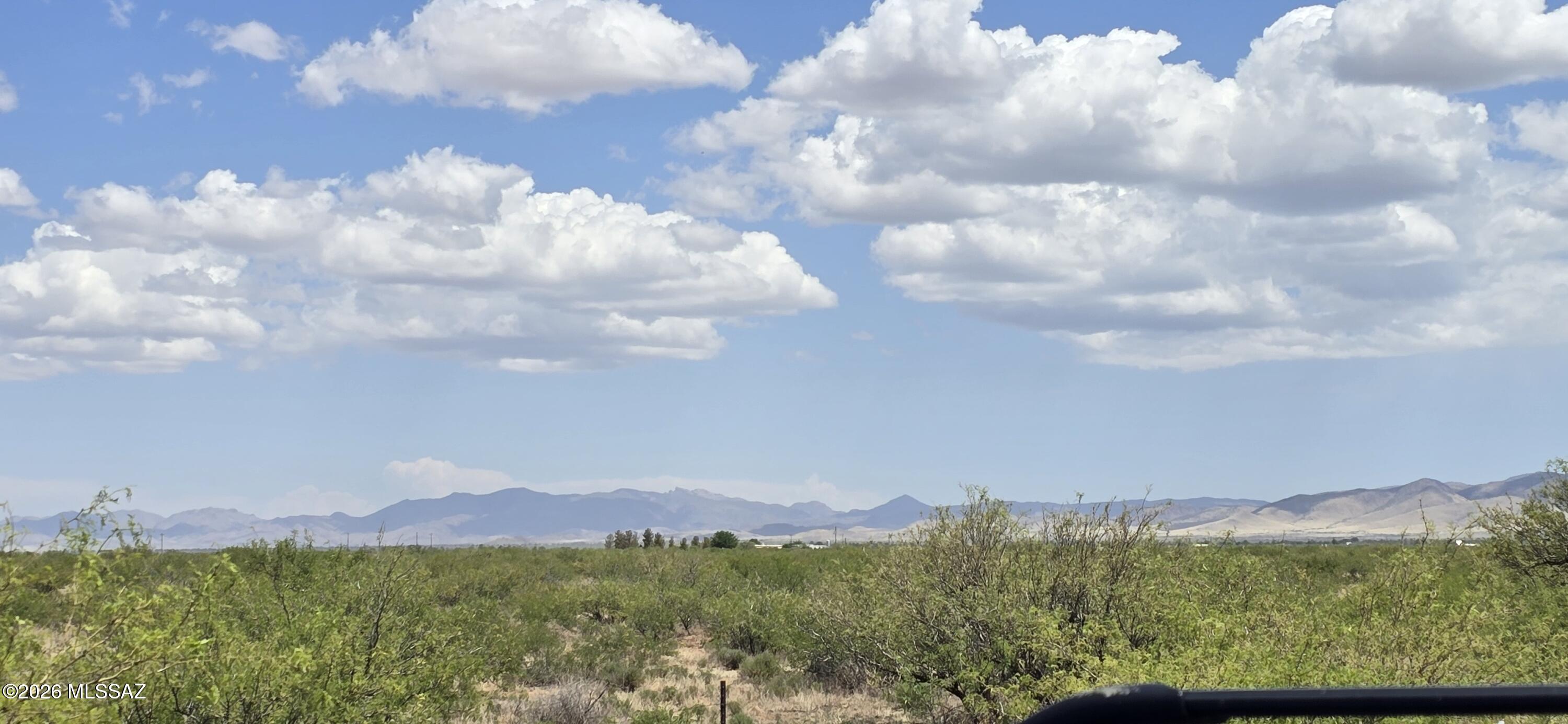 Rural living on 8 wide-open acres with outstanding 360° views across the Sulphur Springs Valley. Zoned RU-4, allowing manufactured homes, tiny houses, or site-built construction with no HOA restrictions. An owner-builder permit is available, offering exceptional freedom to start your vision. Electric and phone are approximately 60 ft from the property line. The land is flat, usable, and partially fenced along the front and east side. Enjoy a mild year-round climate and endless horizons in every direction.