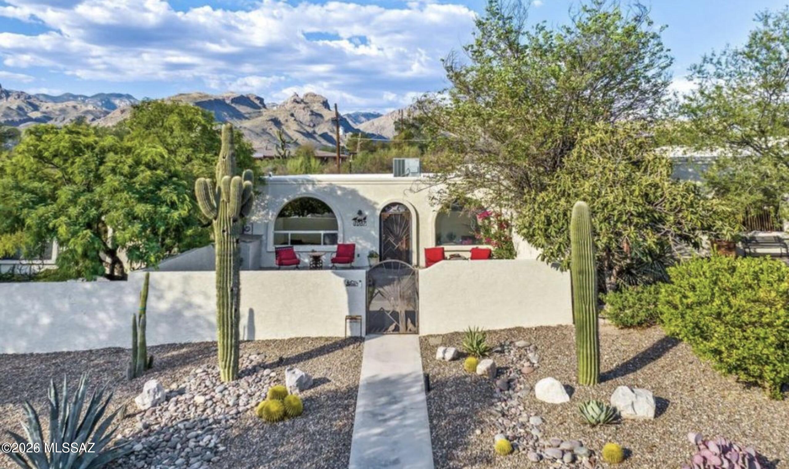 Single level living in desirable Sabino Canyon with large storage area for the outdoor enthusiast plus 2 car garage! Beautiful gated, walked private courtyard with grass and irrigation for outdoor enjoyment. 3 bedroom and 2 bath, updated and professionally decorated. Ideal combination of low maintenance outdoor living, and immediate access to shopping and dining. One of the largest lots in subdivision, with professional desert landscaping surrounding private walkway to gated entrance to home. Nestled in private enclave of the very quiet Hidden Valley Townhome Community with low HOA, in the highly desirable District 16 schools.  2000 steps to Sabino Canyon Recreation Area and out your door access to world class biking and hiking. This completely updated townhome, painted inside and out in January of 2024, new roof -2020, new HVAC 2026 -under warranty, is impeccably maintained. New kitchen cabinetry, quartz counters and pantry. If you are looking for a property as a full time residence with seclusion, outdoor living and plenty of storage OR ideal for a snow bird (lock and leave) get-a-away, this property is perfect. Highlights are the gorgeous decor, large outdoor walled courtyard with decorative iron gates, picturesque desert landscaping and oversized 2+ ENCLOSED garage with enclosed lock-off storage areas. Brand new full size washer and dryer. New light fixtures, interior door hardware and light switches.  Steps to pool and spa. Large Primary bedroom with sitting area and en-suite updated bathroom and his and her closets with new mirrored sliding closet doors. Secondary bedroom has an updated en-suite. This home has neutral decor with mission style architectural windows. Private and quiet. Both back and front of property face greenway. Gated and walled large courtyard has drip system and sprinklers. Can be sold turn-key furnished with luxury linens, fully stocked kitchen, and decor.  Just bring your suitcase and enjoy beautiful Tucson in the picturesque Sabino Canyon. Priced  for quick sale. Existing home warranty conveys to new owner.
