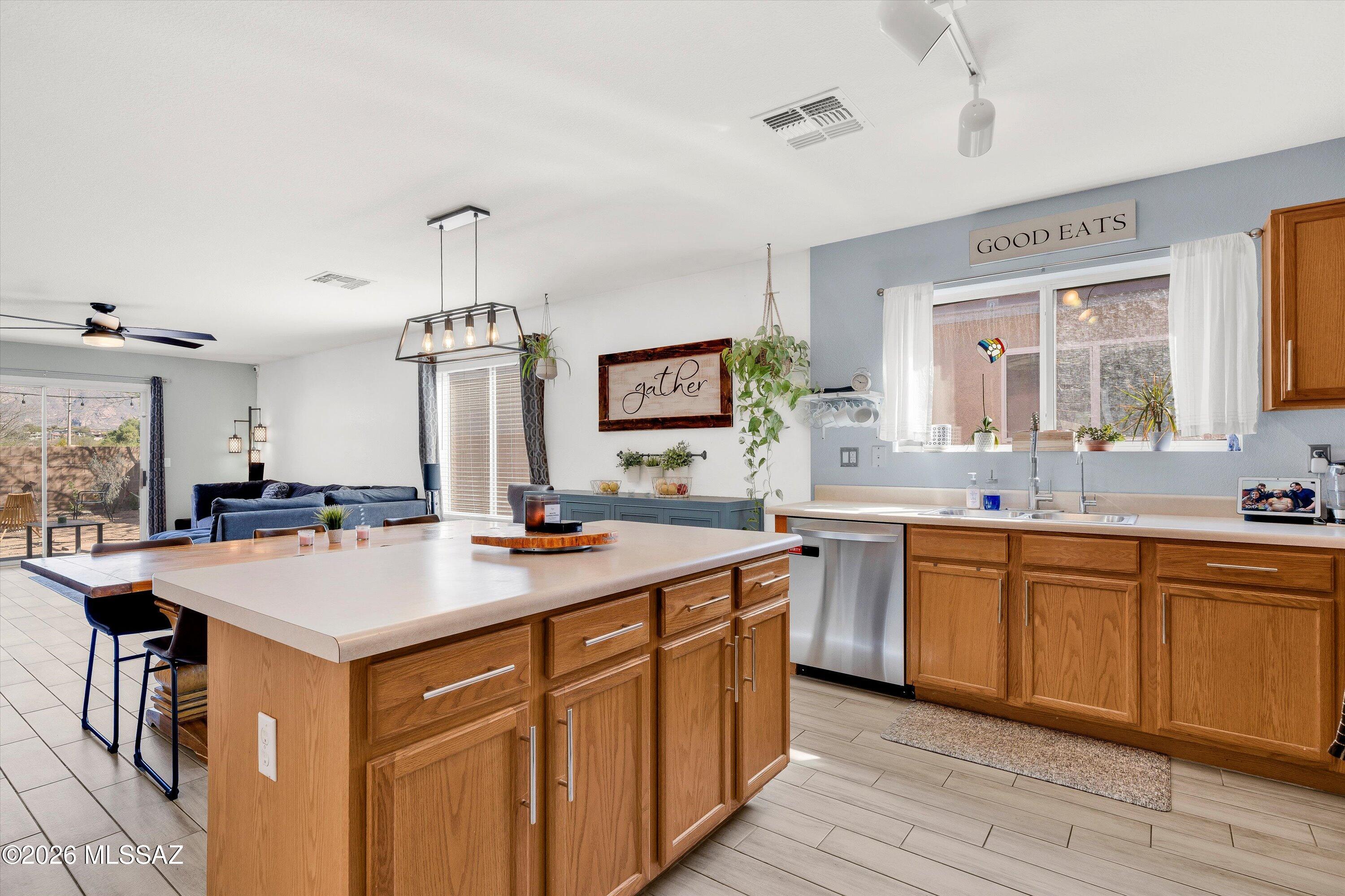 Unique opportunity in the desirable Riverhaven neighborhood! This single-story 4-bedroom, 2-bath home offers a rare blend of space, functionality, and location. Step inside one of two versatile living areas that's perfect for everyday living, a library, or a comfortable space to entertain.

The open-concept kitchen flows seamlessly into the dining area and the second living space, complete with a cozy electric fireplace and direct access to the backyard, ideal for indoor-outdoor living.

Enjoy stunning mountain views and a backyard that's a blank canvas, ready for your personal touch, whether you envision an outdoor oasis or a low-maintenance retreat. The two-car garage provides ample parking, additional storage, and most importantly, protection from the Arizona sun!

The Riverhaven neighborhood is designed for an active lifestyle, featuring sidewalks throughout and convenient access to The Loop just down the street. Located near shopping, dining, schools, and hiking, this home offers an exceptional opportunity to enjoy the very best of Tucson living.