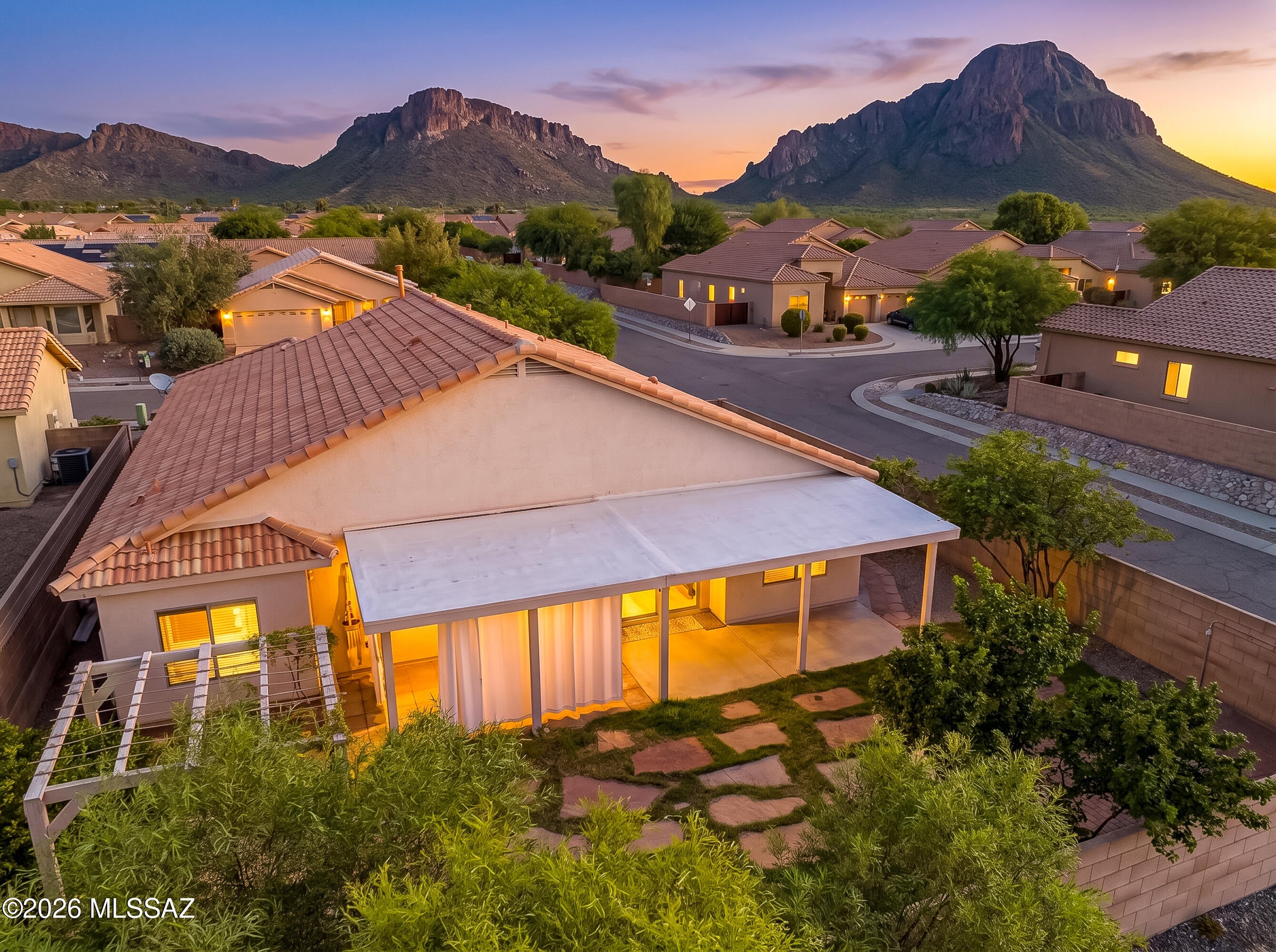 Enjoy spectacular Tucson Mountain views and unforgettable golden Arizona sunsets from this beautifully situated 4-bedroom, 2-bath, 1,946 SF home and two-car garage in desirable Tucson Mountain Sanctuary. Ideally positioned on a corner lot, this inviting home blends over $70k thoughtful updates, comfortable living and wonderful outdoor spaces with the beauty of the Sonoran Desert. The updated kitchen is the heart of the home, showcasing stunning granite countertops, warm wood cabinetry, 2024 stainless-steel appliances, a gas range and oversized center island with casual seating. The kitchen flows seamlessly into the dining and great room areas, creating an ideal space for entertaining. Classic Southwestern design, a tile roof, mature shade tree landscaping creates welcoming curb appeal. Step inside to a bright, airy interior where soaring vaulted ceilings and abundant natural light enhance the open, spacious feel. The living room features neutral tile flooring and a charming bay window overlooking the front landscaping. 

The owner's suite provides a private retreat with an en-suite bath and walk-in closet. Additional conveniences include a laundry room with a full-size stackable washer and dryer and a newer Rheem HVAC system (2024) and water heater (2025).

The backyard is designed to enjoy Arizona living year-round. Relax beneath the extended covered patio, unwind in the private hot tub or enjoy the charming vine-covered pergola. Flagstone pathways meander through mature landscaping, grassy areas, raised garden beds and a variety of established citrus trees. 
Outdoor enthusiasts will appreciate being just minutes from Tucson Mountain Park, Old Tucson and the Arizona-Sonora Desert Museum, with hiking and recreation nearby. A neighborhood park with covered playground equipment adds another nearby amenity, and Tucson International Airport is approximately a 20-minute drive.

A wonderful opportunity to enjoy an updated, move-in-ready home surrounded by some of Southern Arizona's most beautiful scenery!