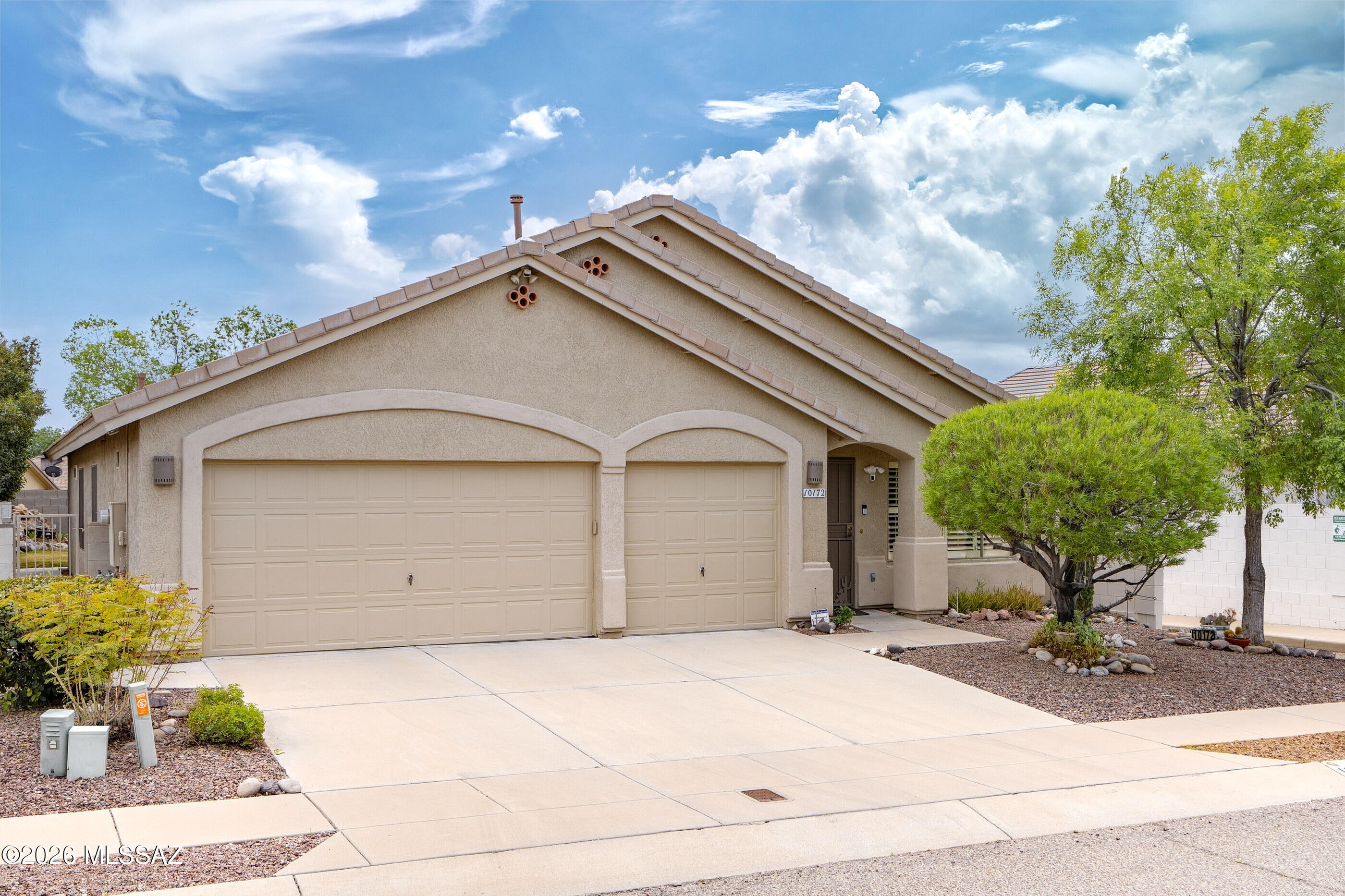 Welcome to your dream home in a desirable east Tucson neighborhood, Austin Point. This beautifully maintained 4bd/2ba home offers a split-bedroom floor plan, providing privacy for everyone! Step inside and be greeted by soaring vaulted ceilings and an abundance of natural light, creating an inviting and spacious atmosphere. The large kitchen is a chef's delight, featuring Corian countertops, plenty of cabinetry, and a generous layout--ideal for preparing meals and gathering with friends & family. Relax in the welcoming family room area, where a cozy fireplace sets the scene for those chilly desert evenings. Both bathrooms have been tastefully updated, ensuring comfort and style throughout. The primary suite offers a peaceful escape, with ample closet & storage space. Got toys? You'll love the rare 3-car garage! Step outside to enjoy your private backyard--ready for entertaining, gardening, or simply unwinding under Arizona's beautiful skies. Neighborhood park at the end of the street and only minutes from shopping, dining, and schools - this home delivers convenience without sacrificing serenity! This move-in-ready gem combines comfort, style, and practicality - imagine the possibilities in your new Tucson home!