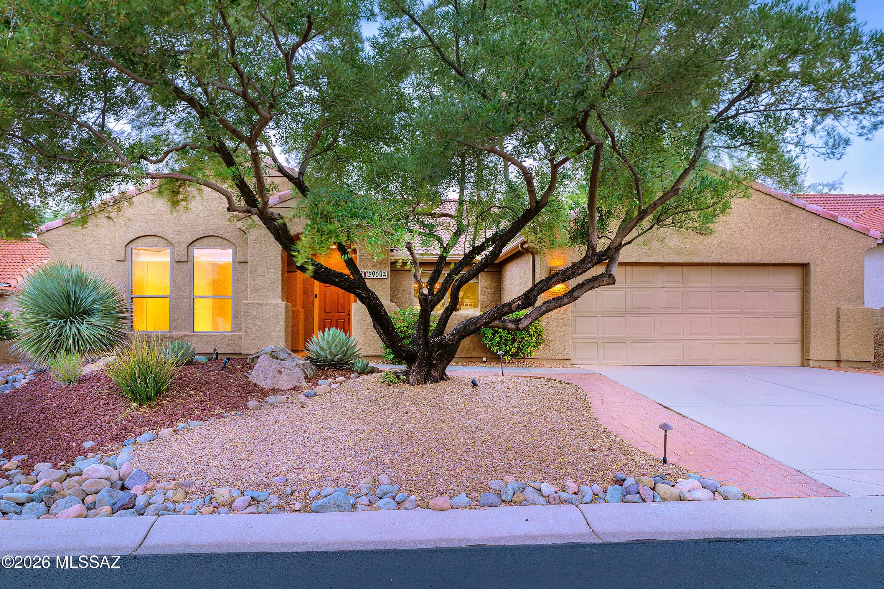Just a short walk from MountainView Golf Club, this Silverton model in SaddleBrooke Two sits on a generous 0.24-acre lot surrounded by mature landscaping and established outdoor living areas. Offering 2,083 square feet, two bedrooms, two bathrooms, a separate den, formal living and dining rooms, a family room with a breakfast nook and bar seating, plus a large screened-in Arizona room, the home offers something increasingly valuable: a variety of spaces to enjoy, each with a purpose of its own.

A welcoming courtyard entry offers a lovely setting for morning coffee or dining outdoors. Inside, the thoughtful separation of living areas makes room for hosting dinner parties, spending time with friends, pursuing hobbies, or simply enjoying a little space of your own. The formal living and dining rooms provide dedicated entertaining areas, while the family room, kitchen breakfast bar, and breakfast nook offer additional spaces to gather throughout the day. A separate den provides room for an office, library, or creative pursuits without sacrificing either bedroom. Beyond the interior living areas, the large screened-in Arizona room creates yet another setting for dining, entertaining, or enjoying the surrounding greenery, complete with dedicated irrigation lines for potted plants.

The backyard is a standout feature, with mature trees, palms, flowering plants, and Meyer lemon, grapefruit, and lime trees creating a beautiful setting across the generous lot. A brick-paver walkway leads through the landscaping to a shaded gazebo with its own paved dining patio, while brick edging defines the surrounding planting areas. Irrigation throughout the landscape supports the established greenery, and the separate outdoor gathering areas offer even more ways to enjoy the property.

The flexibility of this floor plan extends well beyond the home's interior, with the amenities of SaddleBrooke Two close at hand. Just a short walk from MountainView Golf Club, residents also have access to three amenity complexes at MountainView, DesertView, and The Preserve, offering two 18-hole golf courses, dining, swimming pools, fitness centers, pickleball, tennis, performing arts, and a wide variety of clubs and activities.
