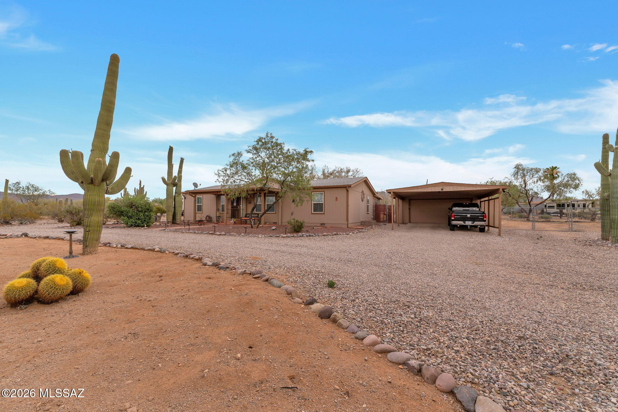 Beautifully maintained corner lot home in desirable Picture Rocks West subdivision with paved streets and awesome mountain views includes a fully fenced rear yard, 2 car garage with attached 2 car carport, natural gas, 12 x 38' screened in Az Room, space for RV with 50-amp plug. This home with 2 x 6 construction, auto blinds in windows, updated kitchen and baths, split bedroom floor plan, no HOA, easy care front and rear and includes ALL APPLIANCES. Professional pictures to be uploaded June 16th and live and on keysafe with courtesy call to broker June 16th.