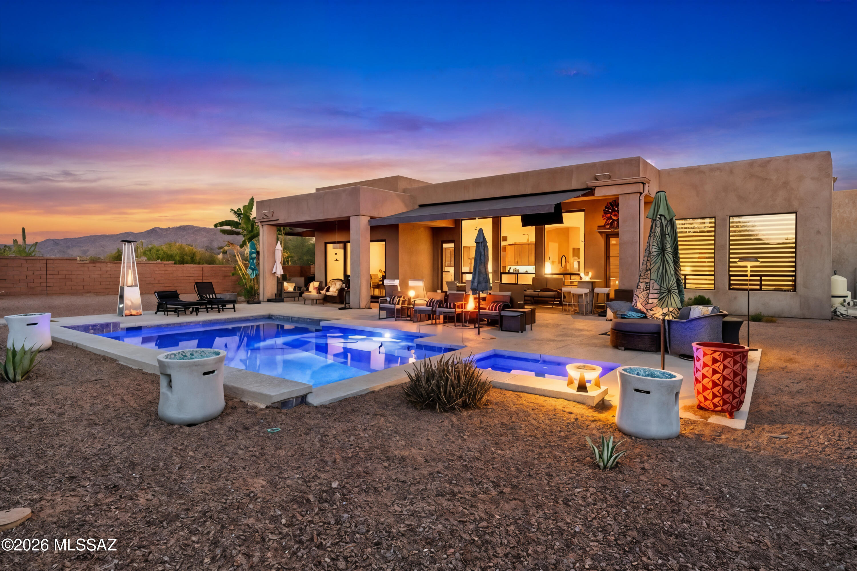 Gorgeous contemporary Oro Valley Home with all the bells and whistles. Integrated smart features throughout. Upgraded indoor - outdoor premium sound system ($15k) integrated within the home and controlled by a tablet. Top of the line Monogram appliances with smart technology featuring wifi connectivity and app (remote) monitoring.
Open floor plan with neutral colors, 12ft ceilings with niches and tray ceilings throughout the home and top-of-the-line materials. Window covering on large picture windows in the great room are remote controlled with multiple opening settings.
Custom storage throughout the home by Closet Trends.
Sightless solar panels were added to the home approximately three years ago - which cuts the electric bill by 60% throughout the year. Central vacuum throughout the home including the garage and workshop space. 

Highly desirable and hard to find climate controlled and insulated 4-car garage ($20k upgrade for insulation) that has an additional 300 sq ft (approximately) of storage/workshop area. Also includes cabinets and countertops built out by Closet Trends. The garage includes a 50 amp Tesla charger and industrial ice maker. 
A portion of the garage could be used for your home gym, pilates studio, man cave, workspace or custom tailored to your own personal needs.

The front yard is beautifully landscaped with desertscape matching the other 26 homes in this beautiful neighborhood. The medium-sized courtyard showcases the morning sunrise over the Catalinas and is ready for the new owners to put their personal touches on it. 

The home beautifully transitions from indoor to outdoor living with your own private oasis where neighboring homes are out of sight. Gorgeous resort-style pool with 4 bar stools and sun shelf seating and umbrella area. The pool is self cleaning and comes with a custom-colored light system controlled by your phone. As mentioned earlier, top-of-the-line sound system and a large television for those who don't want to miss the big game. The pool area has six gas lines installed and ready to go for fire pits and/or tiki torches. There's an additional gas hookup for a BBQ grill. Also has a very large covered patio area that has an additional extendable electronic shade for even greater coverage. A large desert buffer sits behind the home with unobstructed desert views. Both front and backyard drip systems are on timers. There is a water trough behind the open steel fence also on a drip system for those who would like to get a glimpse of the local wildlife in the peaceful mornings or scenic evenings (deer, javelinas, quails, bobcats) 

The subdivision features a community park and fenced dog park. Being in Oro Valley, the home is situated within 5-10 minutes of great public and private golf courses. For bicycle enthusiasts, Oro Valley is connected to the Chuck Huckleberry Loop - a 137 mile car-free paved trail system that connects Oro Valley, Marana and Tucson for bikers and runners alike. Oro Valley is also one of the top spots in the country for stargazing. Because of the town's strict ordinances on light pollution and observatories located nearby, constellations, planets and even the Milky Way are visible to the naked eye.