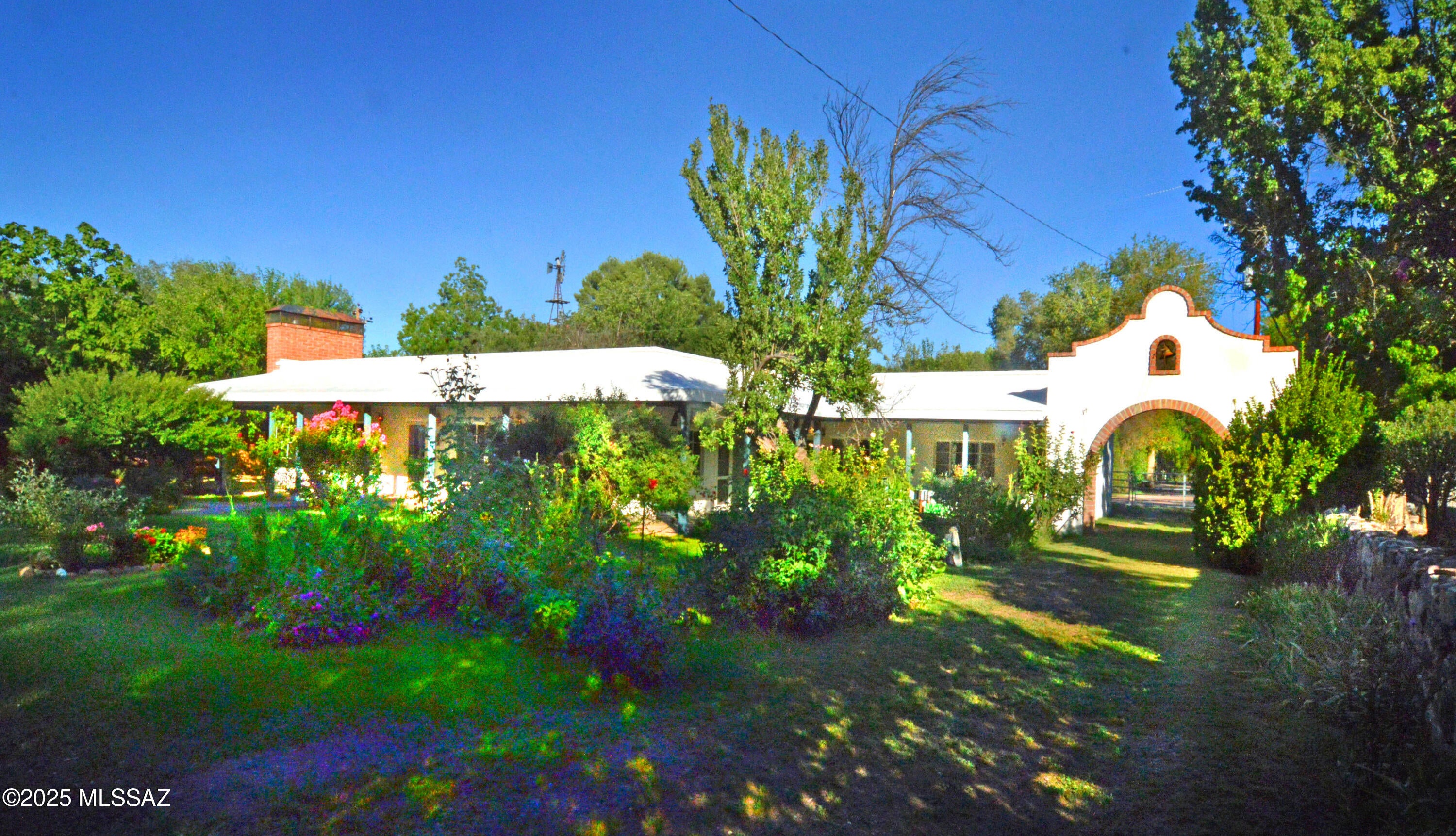 Uniquely designed family home providing 3 separate but complete Residences, each with their own Living areas, Bathrooms & Kitchens, & private entrance, giving each the convenience of personal space. A great home & property setting for intergenerational living & visitors. This c.1962 vintage adobe/masonry family home is in excellent condition & enjoys a floorplan ideal for single or multi-unit possibilities. The 2248sf main residence has 2Be/3Ba w/large Living & Dining areas, Kitchen, Study & 780sf Studio/Apartment. The lush 0.4 acre parcel (2.5+ Town lots) is fully fenced & has Town water & sewer, natural gas + grandfathered PRIVATE WELL. The wooded grounds & mature plantings are lovely & the overall park-like setting ideal for all variety of gardening interests & other special projects.