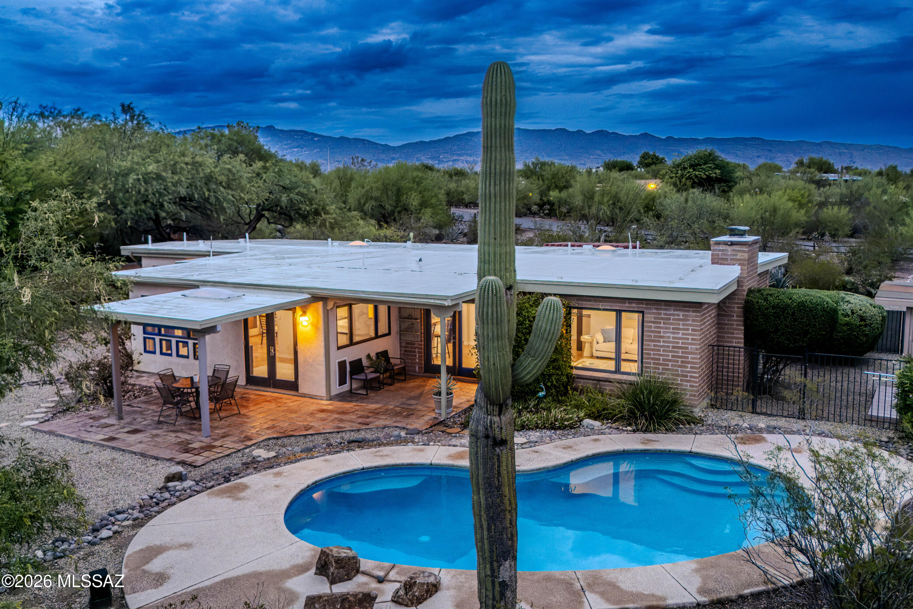 Exceptional value in the highly sought after Tanque Verde Valley. Beautifully updated and set on 1.04 acres at the base of Mount Lemmon, this 4 bedroom, 3 bath home captures breathtaking Catalina Mountain views and offers a highly desirable split floor plan with two private primary suites on opposite sides of the home, ideal for guests or added flexibility.

Natural light fills the home through multiple French doors, creating a seamless connection between the inviting interior and the surrounding desert landscape. The spacious layout features a fireplace, formal dining area, Arizona room, and a beautifully updated kitchen with concrete and aggregate countertops, a butcher block breakfast bar, open shelving, subway tile backsplash, and custom lighting. Recent improvements include a new roof on both the home and detached garage, HVAC system, upgraded electrical panel, fresh interior paint, updated bedroom flooring, a new refrigerator, and refreshed desert landscaping.

Step outside to enjoy multiple patios, including private patios off the primary suite and Arizona room, plus a spacious patio overlooking the sparkling pool with deck jet fountains. Citrus trees, rose bushes, a mesquite grove, and expansive mountain views create a peaceful backyard retreat that is equally suited for entertaining or quiet evenings at home.

A detached two car garage with built in cabinetry and workshop space adds exceptional versatility. Whether you're relaxing by the pool, enjoying your morning coffee on one of the private patios, or watching the sun set behind the Catalina Mountains, this home offers the privacy, views, and Arizona lifestyle you've been waiting for.