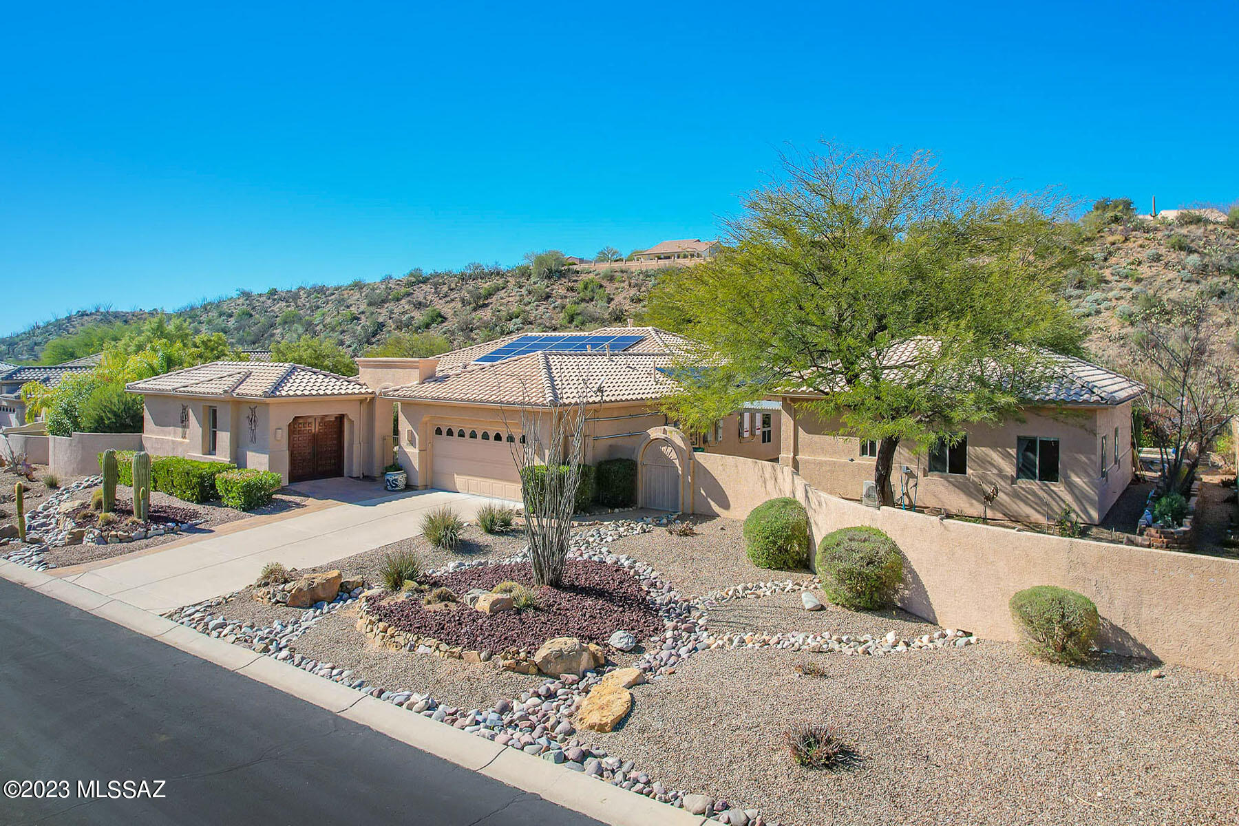 Situated on a 1 acre, resort-like lot with pool, hillside backdrop and front Catalina views. This spectacular retreat boasts a 2BD/3BA (3,161 sf) main home plus detached 1BD/1BA (434 sf) Casita and 1BD/1BA (704 sf) Casita w/workshop. Newer roof & leased solar on main home; newer HVAC. Enter the large main living space with tray ceiling, recessed in-wall fireplace, sunroom plus media room. Gourmet kitchen hosts center island and breakfast nook. Main bedrooms feature room-size closets and en-suite baths w/jetted tub & walk-in shower. Gated paver courtyard w/tiered fountain flows to large fire pit patio and trickling water feature. Paver walkway spans side & rear of home boasting lush desert plantings, fruit & shade trees, pool ramada w/bath and lap pool. SaddleBrooke Active Adult Community.