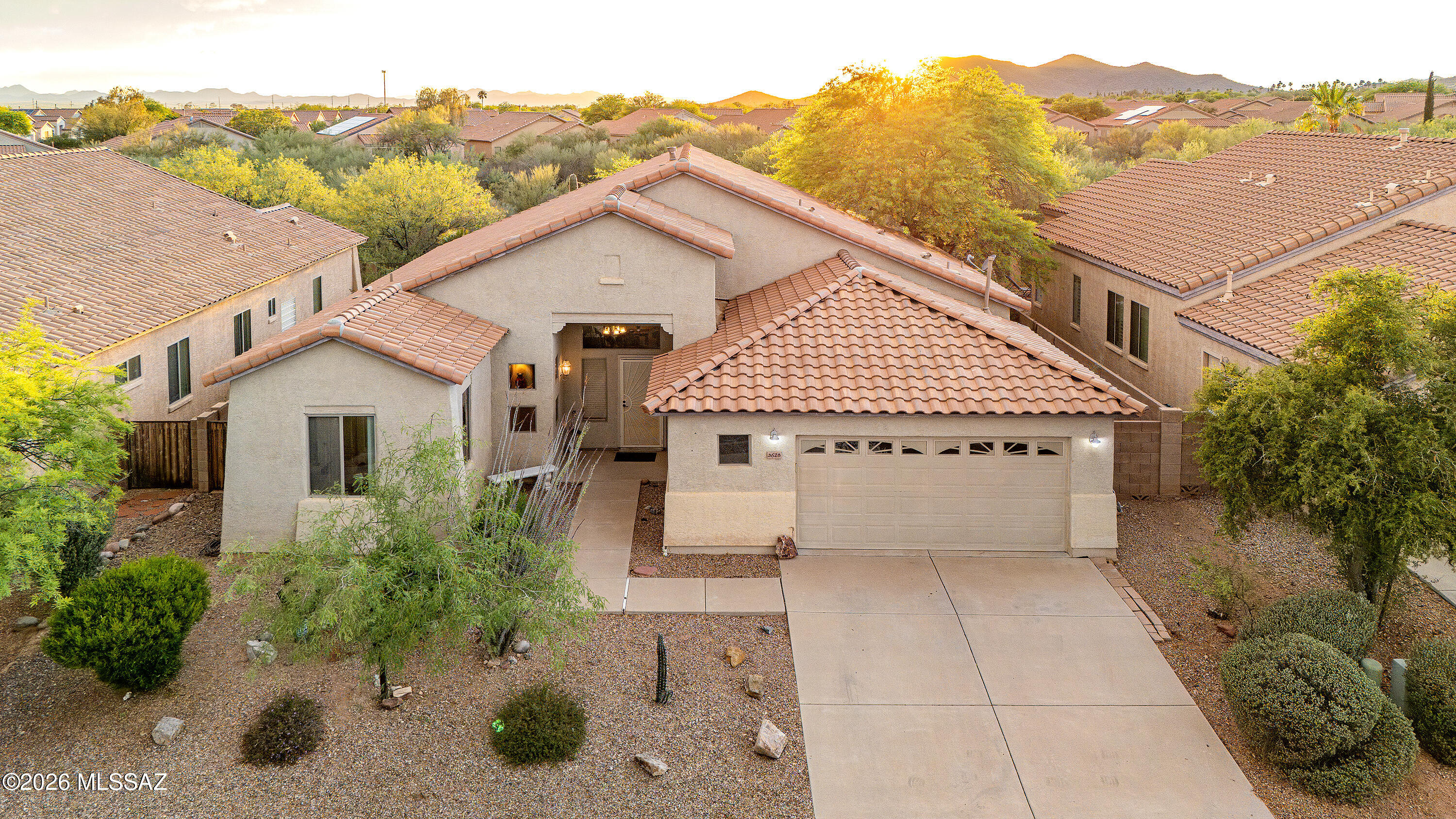 Set against the stunning desert landscape of Southwest Tucson, this well maintained home offers sweeping mountain views, peaceful surroundings, and a spacious open layout designed for comfortable everyday living. Located in a quiet neighborhood with easy access to outdoor recreation, the property captures the beauty of the Sonoran Desert from nearly every angle.
A private courtyard entry welcomes you into a bright interior filled with natural light, soaring ceilings, and expansive living spaces. The open concept design flows seamlessly between the living room, dining area, and kitchen, creating an inviting space for entertaining or relaxing at home. Wood look tile flooring throughout the main living areas adds warmth and durability, while large windows showcase the surrounding desert scenery and incredible Arizona sunsets.
The spacious primary suite features dual vanities, a soaking tub, walk in shower, and generous closet space. Additional bedrooms provide flexibility for guests, hobbies, or a home office.
Outside, the backyard is designed for low maintenance desert living with a covered patio, artificial turf, mature landscaping, and plenty of space to enjoy Tucson's beautiful evenings and mountain views. Whether enjoying a quiet morning coffee or gathering with friends at sunset, the outdoor spaces offer privacy and tranquility in a truly scenic setting.
This is an opportunity to enjoy spacious Southwest Tucson living with incredible natural beauty, a functional floorplan, and a setting that feels connected to the desert landscape.