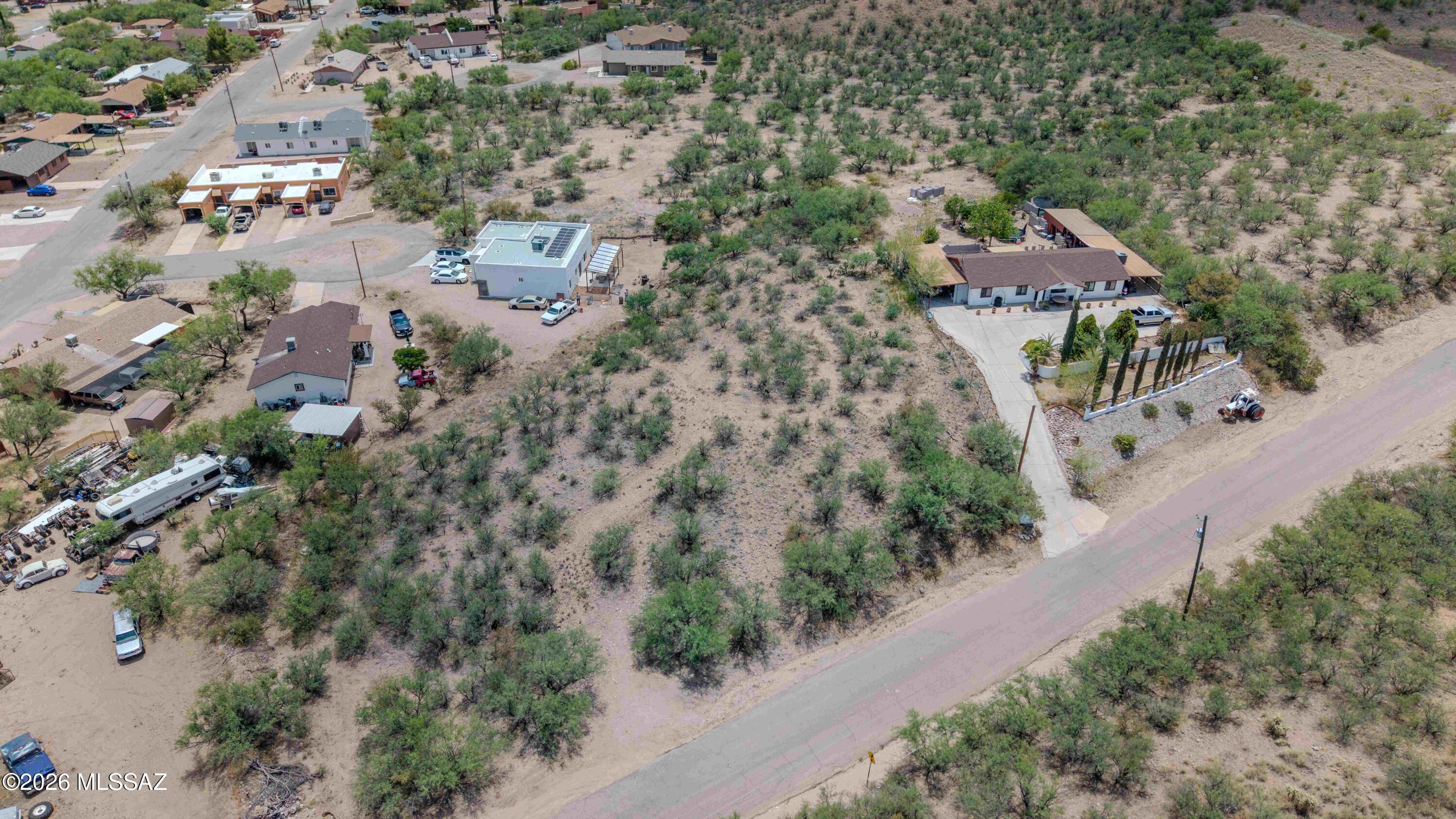 Nestled in the foothills of Rio Rico with stunning mountain views in every direction, this 1.17-acre parcel offers a rare opportunity to build in an established neighborhood with water already available. Surrounded by mature desert vegetation and backing up to open natural terrain, the lot provides privacy while remaining close to shopping, schools, and easy I-19 access. Paved road frontage and a gentle natural setting make this one of the most buildable lots in the area.