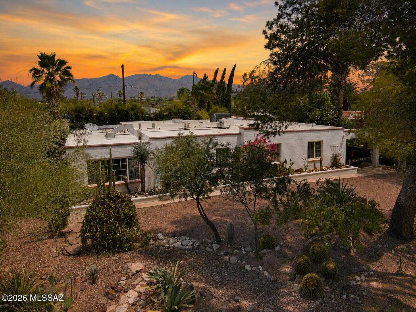 Historic El Montevideo Estates territorial with sought-after guest house in the heart of central Tucson! Rare opportunity to enjoy classic Southwest charm, mountain views, and flexible guest quarters ideal for extended family, visitors, studio, or home office. Historic tax designation adds value and character. Beautiful mature landscaping creates exceptional privacy and a peaceful setting with the quaint elegance of old Tucson. Enjoy indoor-outdoor living with a sparkling pool and covered ramada. No HOA. Conveniently located near shopping, dining, Randolph Park, the zoo, U of A, downtown, and Tucson's vibrant cultural amenities.