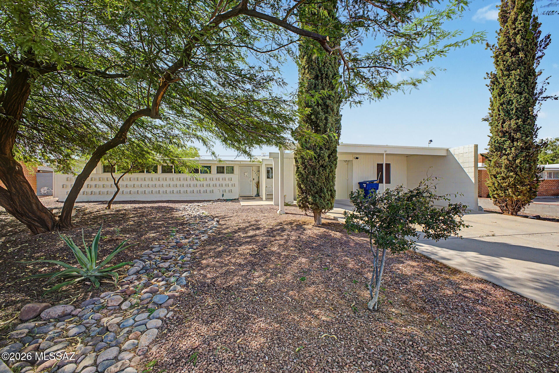 Fantastic opportunity to own this spacious home on a peaceful cul-de-sac with no HOA. This 4-bedroom plus den, 2-bath home offers a flexible layout and room to spread out. Vaulted ceilings, wood-look tile flooring, and a cozy fireplace create an inviting living space, while the kitchen features granite counters, white cabinetry, stainless steel appliances, mosaic tile backsplash, and a pantry. A dedicated laundry area adds everyday convenience. The den and large bonus room offer endless flexibility for an office, hobby room, playroom, or additional living space. Thoughtfully designed for privacy, the guest bedroom is positioned at the separate end of the home. Outside, enjoy a huge backyard with a covered patio, RV gate, alley access, and space to create the outdoor retreat you have been looking for. Large carport provides convenient covered parking. Come see the size, layout, and value for yourself!