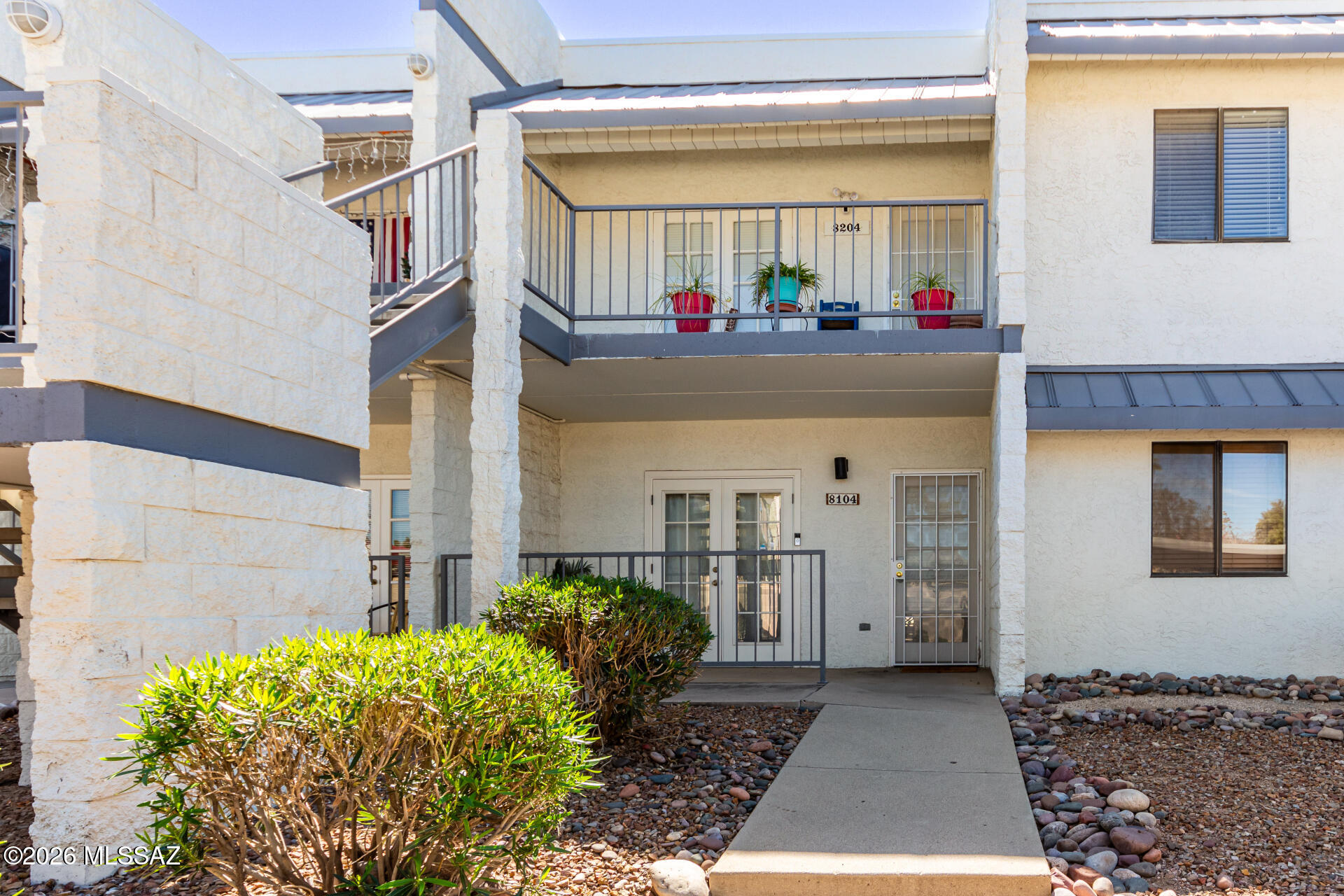 Beautifully maintained 2-bed, 2-bath ground-level condo offering easy, turnkey living. Bright open layout with oversized windows and front and back patios, including a cool north-facing patio ideal for relaxing or entertaining. Steps from the community pool and surrounded by mature landscaping, this home features solid block construction for added privacy and efficiency. HOA covers water and roof, and short-term rentals are allowed--perfect for homeowners or investors.