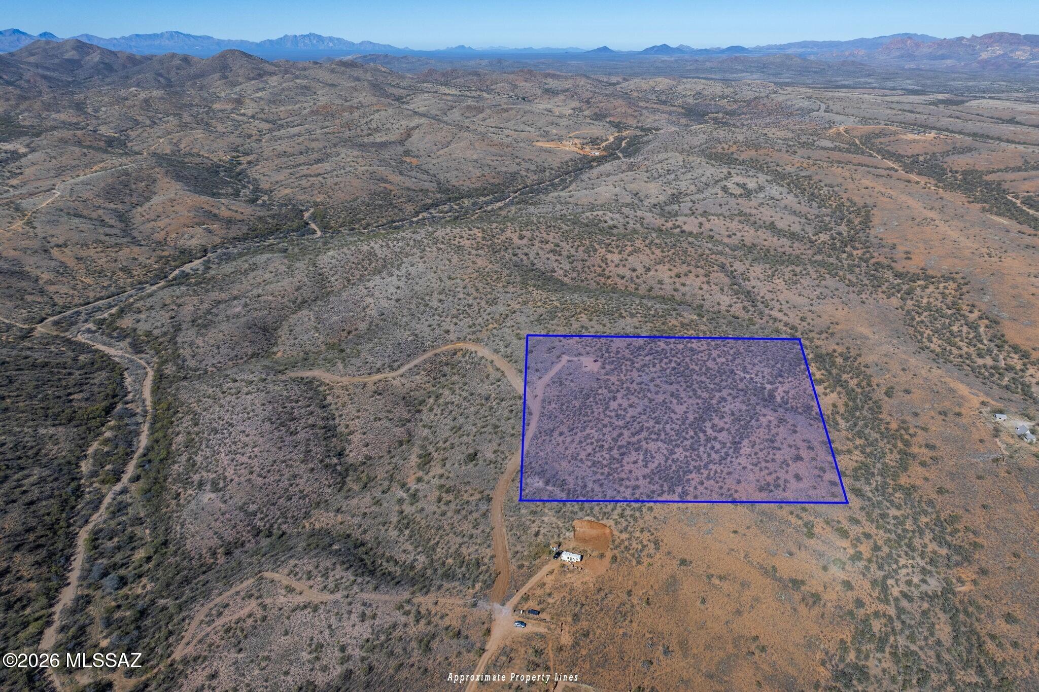 Tucked into the high desert in Arivaca, this 10-acre parcel, known as Loma Roca Vista, offers space, privacy and to-the-horizon views. Bordered on by state land, the setting is expansive and protected. Nestled approx 800 feet off a paved road, it sits within a gated area served by a shared well, with electric 500 feet away. True 360° mountain vistas include Baboquivari Peak to the northwest, the Las Guijas Mountains due west, the San Luis Mountains to the south and the Cerro Colorado range to the northeast. Want to go bigger? An adjacent 10-acre parcel can be yours, for a combined 20-acre private retreat or hobby ranch with plenty of breathing room. Minutes away from the town offers community, local character and a slower, more intentional pace of life.