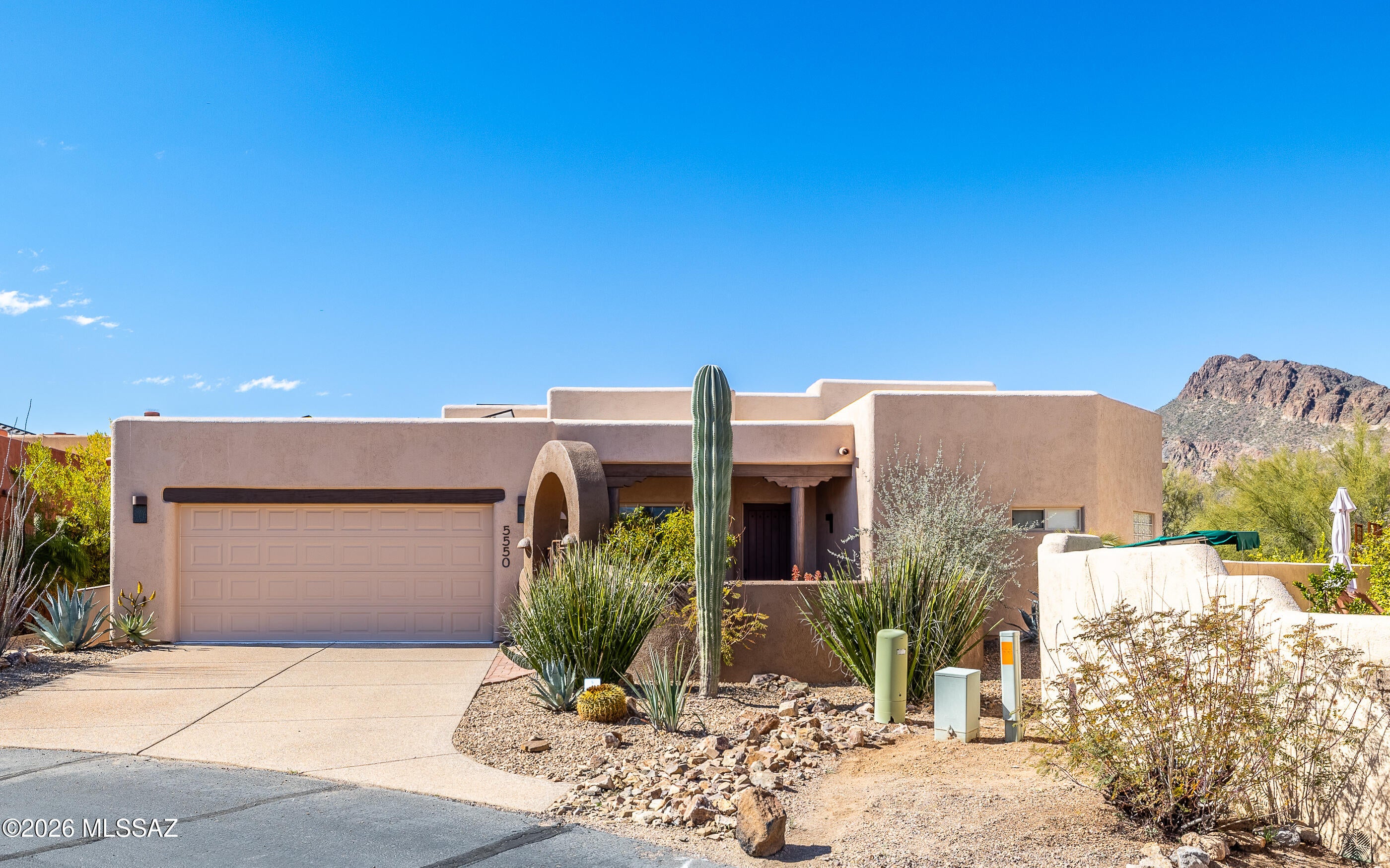 Southwest Beauty: 4 bed, 3 FULL baths, 2 car garage, nestled on a cul-de-sac lot, surrounded by mountain & desert views, w/3 separate yard enclosures to capture sunrise/sunsets. Home features: wood ceilings, Viga beams, custom tile accents, a cozy beehive fireplace w/OWNED SOLAR! This stunning, semi-custom Herder Home is tucked in a gated community w/no immediate rear neighbors, minutes from hiking trails, Gates Pass, Tucson/Saguaro Nat'l Park w/tons of community amenities!  Enjoy plenty of upgrades: stainless steel appliances, cabinet pullouts, hard surface flooring (no carpeting), 2 Trane 16 seer HVAC  units (2023), 80 gal H2O heater (2023), 800 gal, H2O harvesting, custom backyard gates & trellis, & outdoor kitchen w/fireplace & integrated benches. MUST SEE UPGRADE SHEET & VIDEO!!