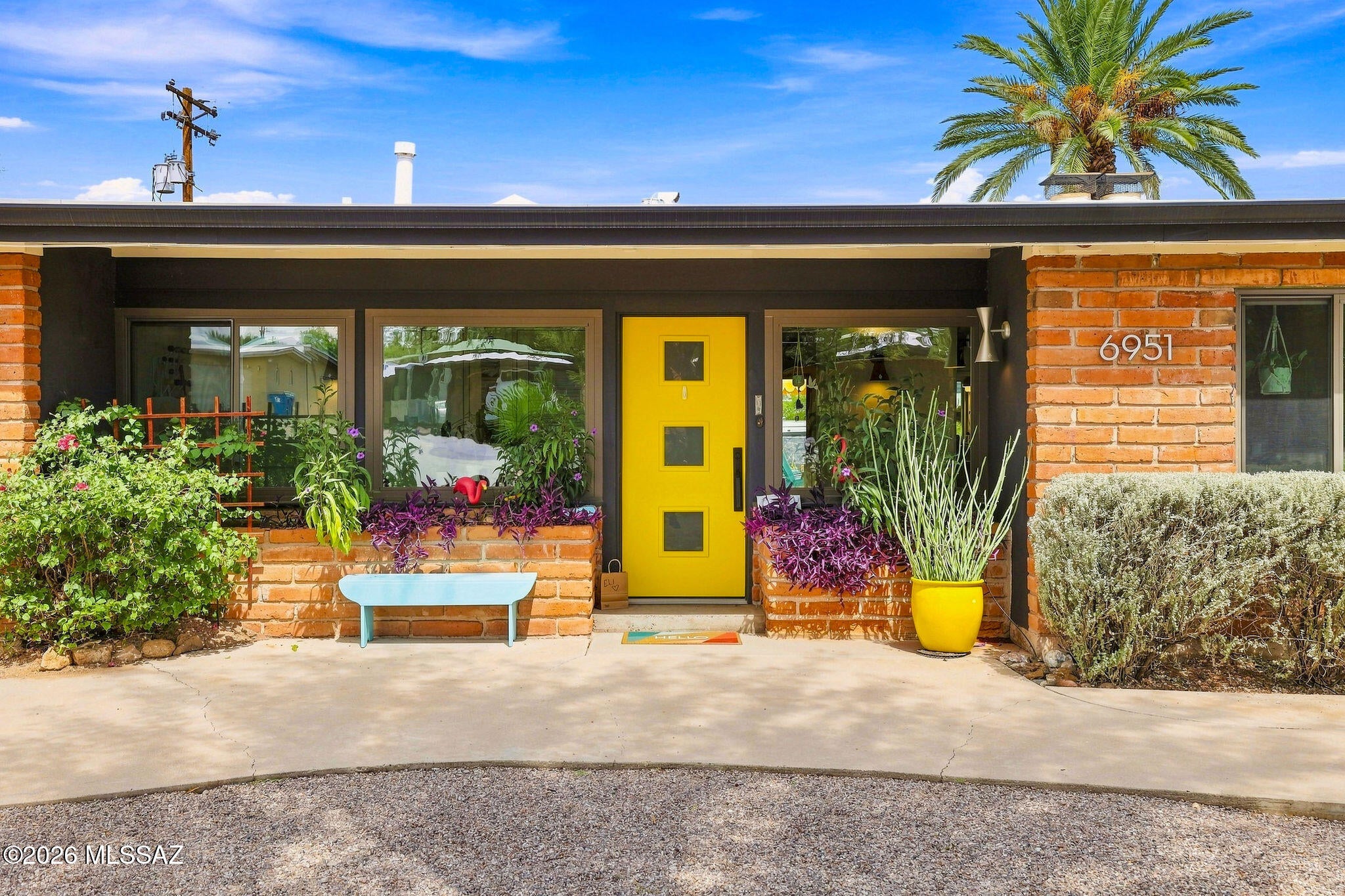 Welcome to historic Indian Ridge Estates, where iconic Mid-Century Modern architecture meets a vibrant, design-forward remodel. This 1955 Lusk ''Riviera'' offers 1,906 sq. ft., 3 bedrooms and 2 bathrooms, with walls of glass, tongue-and-groove ceilings, exposed beams, a dramatic pass-through fireplace and incredible natural light. The remodeled kitchen features sleek cabinetry, quartz counters, stainless appliances and bold geometric tile, while updated baths continue the retro-modern aesthetic. Step outside to your private oasis with a new sparkling pool, mature landscaping, citrus trees, multiple entertaining areas and Catalina Mountain views. Andersen windows, newer HVAC, foam-insulated roof and a 2-car garage add comfort and function. Historic designation offers property tax savings! A truly one-of-a-kind Tucson MCM gem!