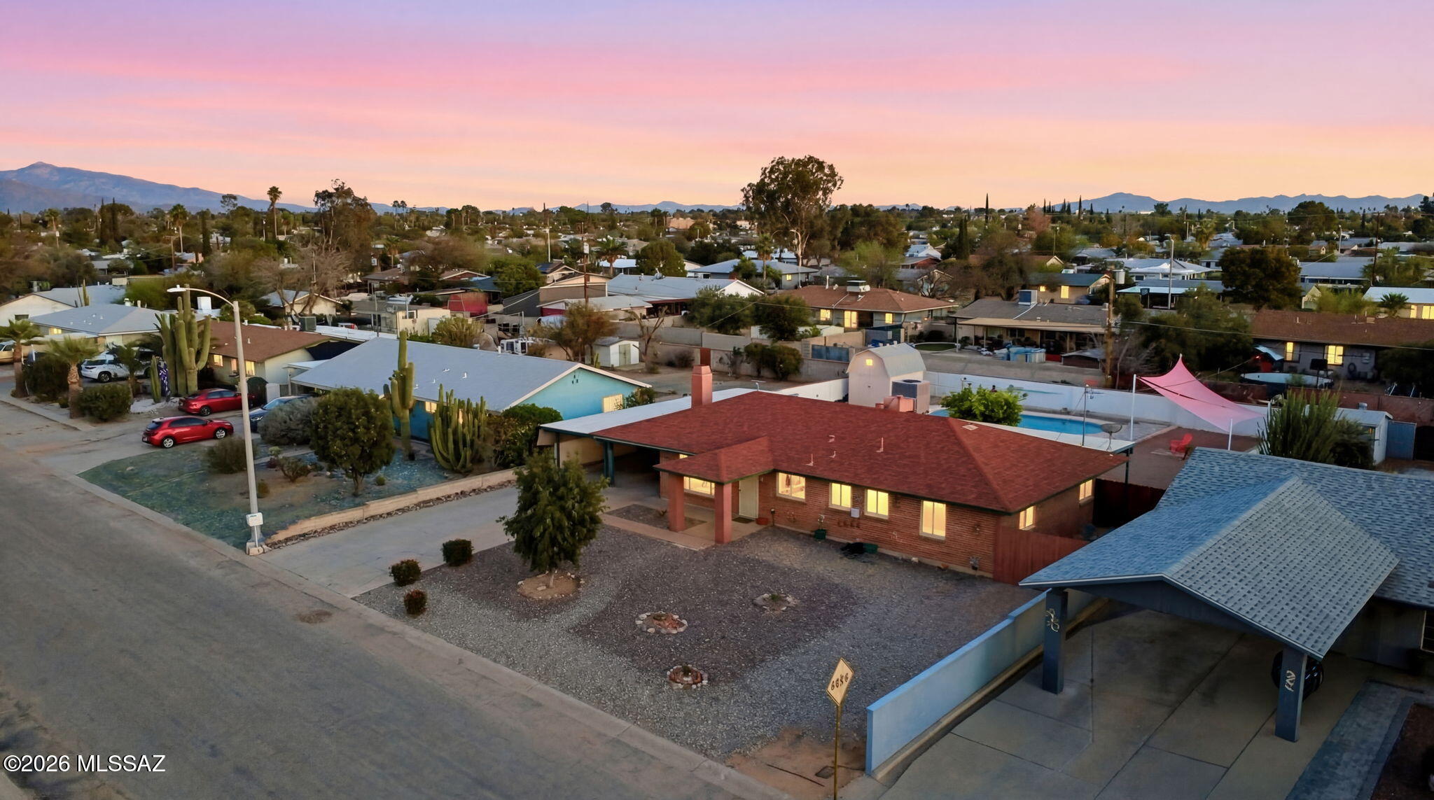 Mid-Century Charm Meets Modern Upgrades in Tucson, AZ...They don't build them like this anymore... and that's exactly the point! This 3BD/2BA, 1,661 sq ft brick beauty in San Pueblo Village sits on nearly 1/4 acre & is packed with thoughtful upgrades: new roof and HVAC, triple pane windows, 200-amp panel, tankless water heater, & tile floors throughout. French doors open to a covered porch & a peaceful, private backyard oasis anchored by a sparkling 8-ft deep pool. A 2-car carport, RV parking with electrical hookup, workshop area, & custom storage shed round out this move-in ready gem. Minutes to Reid Park, Randolph Golf Complex & Downtown Tucson. Character new construction simply can't replicate.