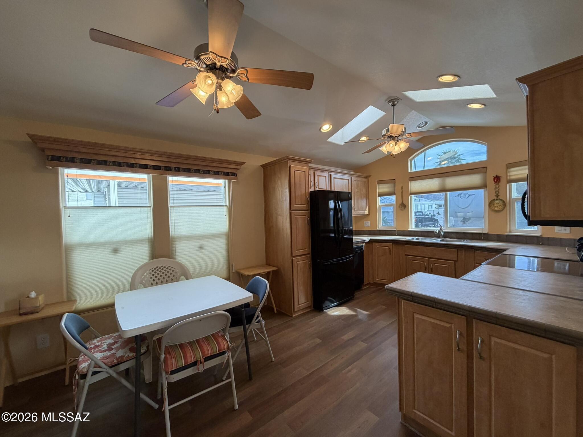 This well‑kept 1Bed, 1 bath manufactured home in Western Way RV (age-restricted) offers an affordable, low‑maintenance Tucson lifestyle. The bright living room and kitchen include a breakfast nook, pantry cabinet, electric range, microwave, and refrigerator. Laminate and vinyl flooring run throughout, with skylights and top‑down blinds adding comfort. Enjoy central air, forced‑air heat, and an electric water heater. Laundry is conveniently located in the large shed with washer & dryer included.  Large Shed has attached cabinets and extra refrigerator. Exterior features include desert‑planted front landscaping, a covered patio, and a carport. Community amenities offer a pool, spa, pickleball, rec center, and exercise facilities for an active lifestyle. Home onl