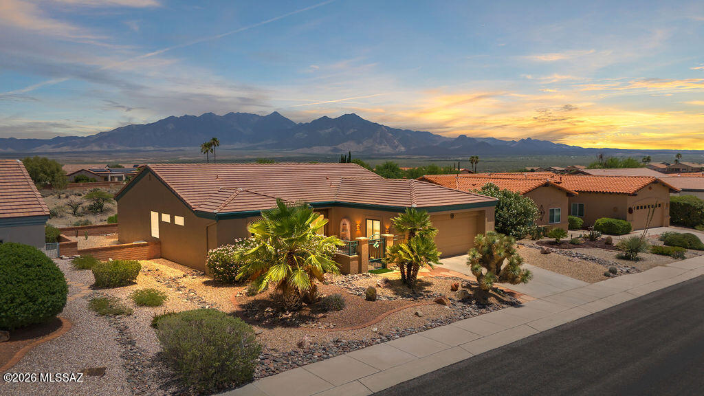 Breathtaking Santa Rita Mountain views set the stage for this beautifully updated 2BR/2BA home offering 1,787 sq ft of comfortable Arizona living. Soaring cathedral ceilings with crown molding create an open, airy feel throughout. The remodeled kitchen features upgraded cabinetry, granite countertops, stainless steel appliances, tile backsplash, and abundant storage. Both bathrooms have been updated with matching cabinetry for a cohesive, modern look. Flexible living spaces include a dedicated office, separate sitting room, spacious living area, and oversized primary suite with walk-in closet. Large windows capture natural light and mountain views. Enjoy outdoor living from the covered patio surrounded by mature, low-maintenance desert landscaping.  This is the home you don't want to miss.