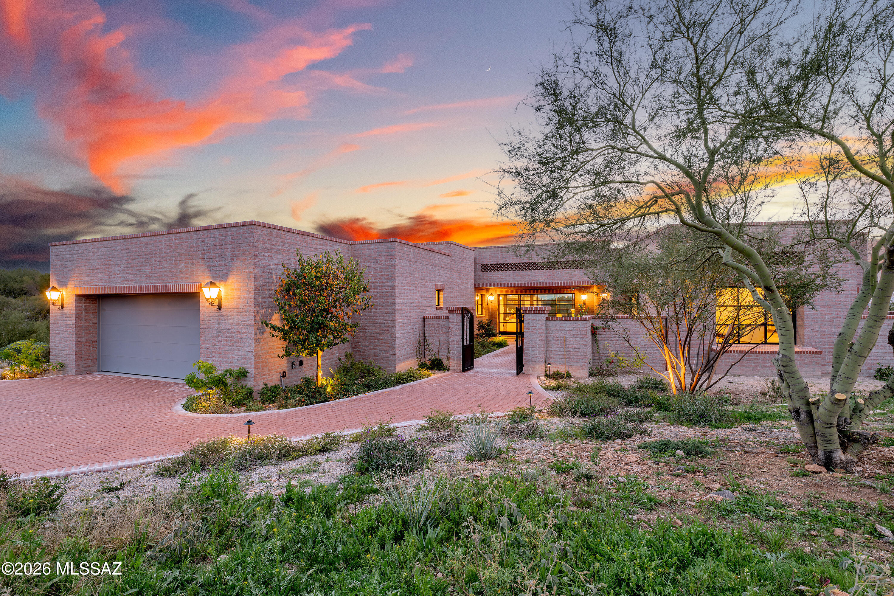 This brand-new, 3,421 sq. ft home is more than a style. Contemporary desert vernacular is an architectural language grounded in place, according to local architectural historian R. Brooks Jeffery, respecting the delicate Sonoran Desert environment, and incorporating time-honored design principles with contemporary interpretations that reflect the cultural characteristics unique to Tucson. Situated on .88 acres at the end of a quiet cul-de-sac in the gated Quintana in the Catalina Foothills, this residence offers unmatched city and mountain views and a level of construction quality rarely seen in today's new builds.

Designed by renowned architect Michael Franks and brought to life by La Quinta Building Company, this 3-bedroom, 3 ½-bath home was built to endure, featuring