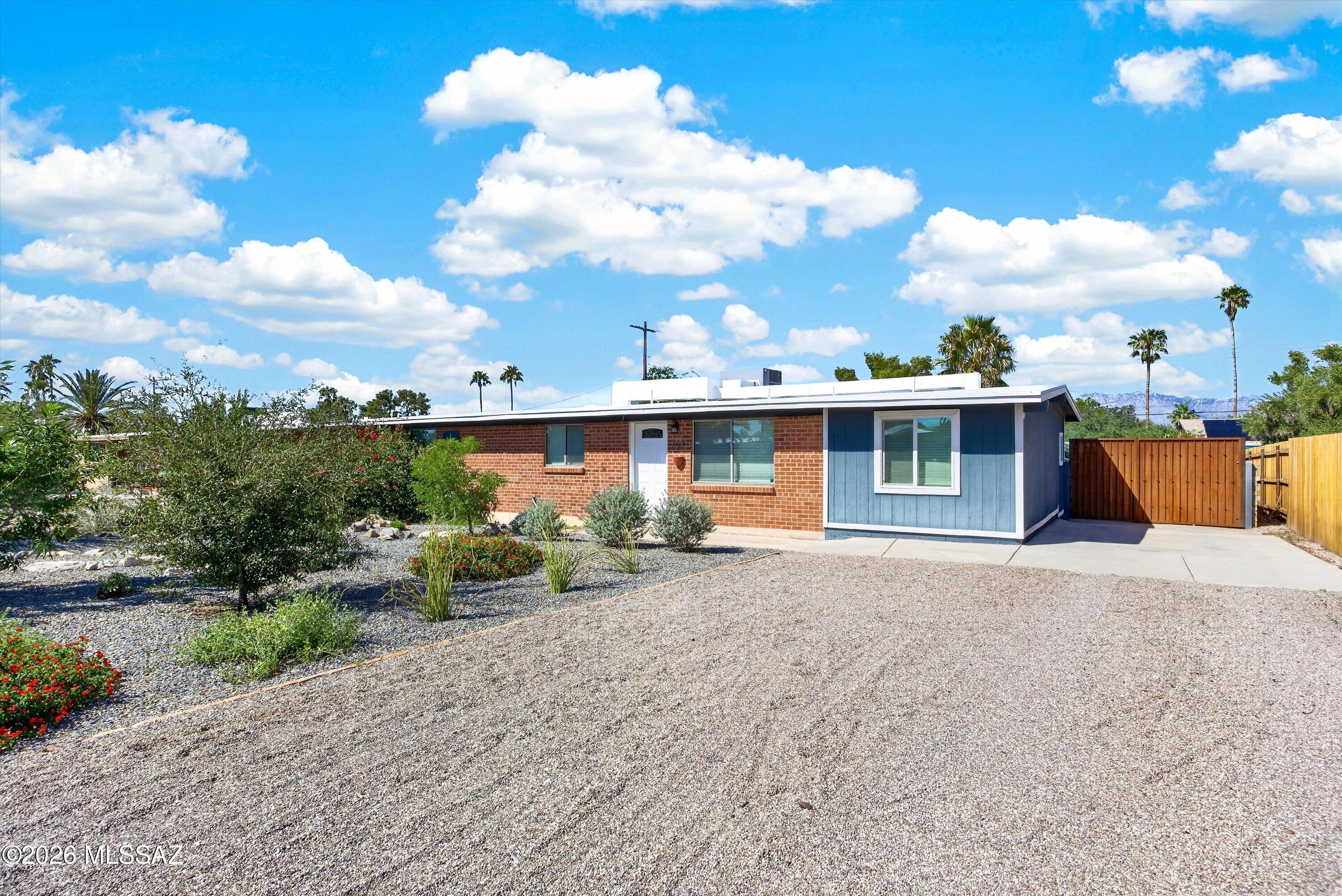Welcome to this charming red brick home in the Terra Del Sol community! This home has been thoughtfully updated and is ready for its next owner. Inside, you'll find wood-look tile flooring, an updated kitchen with white Shaker cabinetry, granite countertops and stainless steel appliances. The spacious owner's suite features a remodeled bathroom with a HUGE custom-tiled shower. Dual-pane windows and ceiling fans add comfort throughout. Outside, enjoy the privacy of a large lot with plenty of room to relax, entertain or simply enjoy the Tucson sunshine. Terra Del Sol also offers residents a community park and pool. A great combination of classic brick character, modern updates and a private outdoor space in a convenient east Tucson location.
