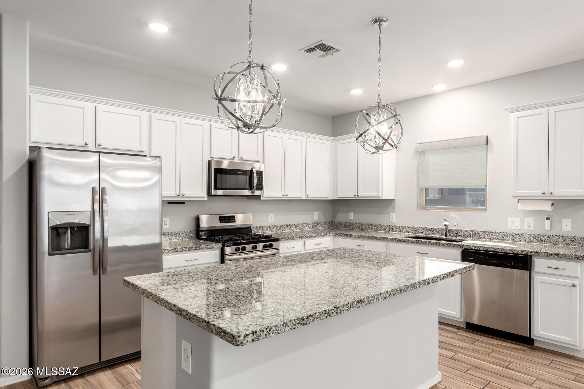 Enjoy iconic Arizona sunsets and mountain views from both the front and backyard of this premium corner lot that backs onto a common area! The interior exudes refined style with recessed lighting and stylish light fixtures, artfully designed wrought iron security door, back yard patio screen, wood-look tile flooring in common areas, tankless water and water softener. French doors open to the versatile den! Come be a part of this beautiful and peaceful community with plenty of amenities including parks galore, pools, clubhouse, fitness center and scenic walking trails.