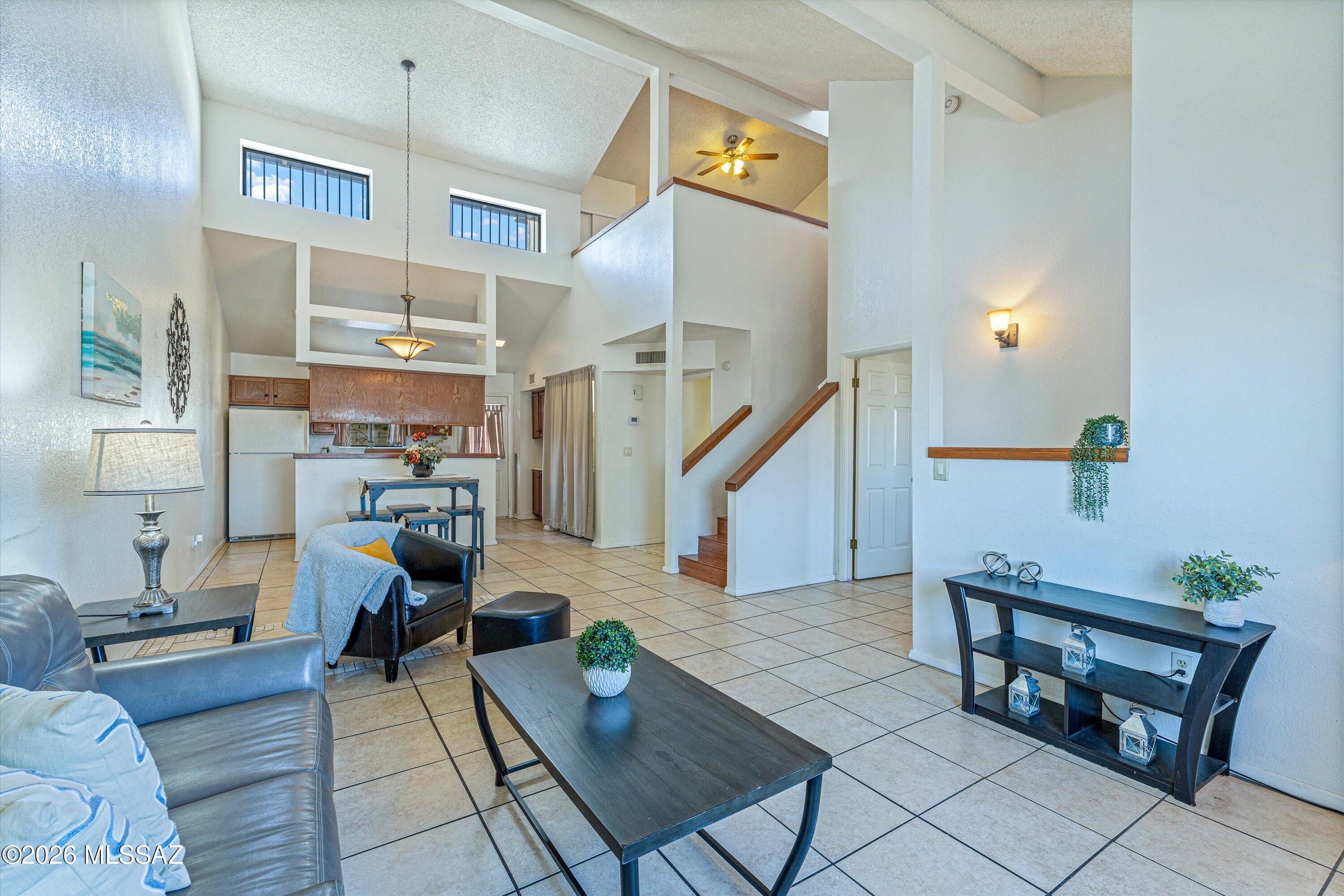 Contemporary Townhouse close to the I-10 freeway, Downtown and U of A! Soaring ceilings let natural light pour in to the great room. Galley kitchen has everything you need including a dishwater and pantry. Indoor laundry closet conveniently located on main floor. Open dining room and living room off of the kitchen. Primary Bedroom on the first floor with large bathroom attached. Bathroom has plenty of storage, walk in shower, dual vanities and separate commode. 2nd bedroom is an upstairs loft with 2 closets and open to below. Back yard is small enclosed patio leading to 2-car covered carport parking with small storage closet. Don't miss this great find!