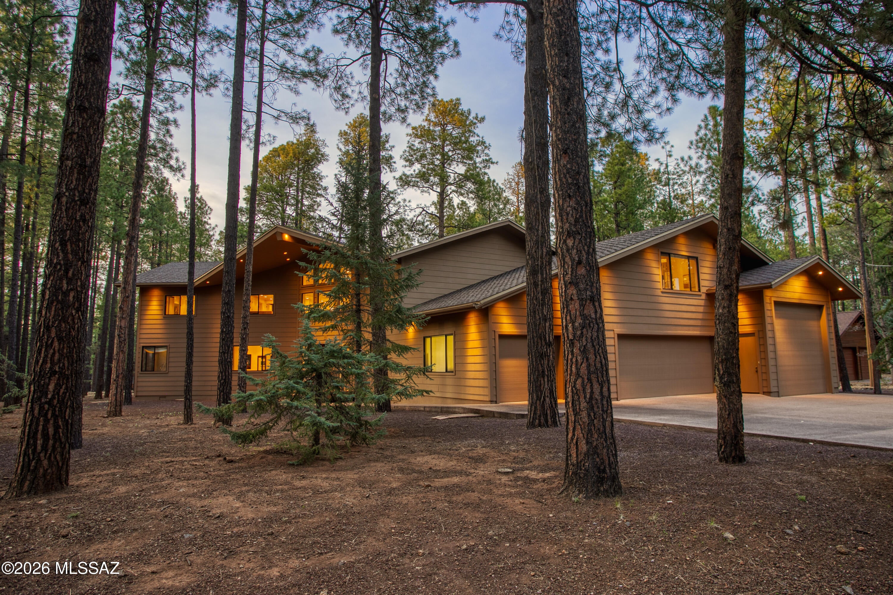 PINETOP COUNTRY CLUB | AN ARCHITECTURAL MASTERPIECE AMONG THE PINES (Don't Miss the VIRTUAL TOUR) Rare. Refined. Utterly uncompromising. Nestled on a coveted corner lot within the prestigious Pinetop Country Club, this extraordinary chalet stands as a testament to what happens when visionary design meets flawless execution -- and neither makes a single concession. Towering pines frame every sightline as you arrive, setting the stage for what lies within. A sweeping wraparound covered deck invites you to breathe in the mountain air and embrace the outdoor lifestyle that makes Pinetop so beloved -- then step inside and prepare to be transformed. Soaring 27-foot ceilings command the main living area, which opens dramatically to the floors above in a breathtaking display of volume and light. A