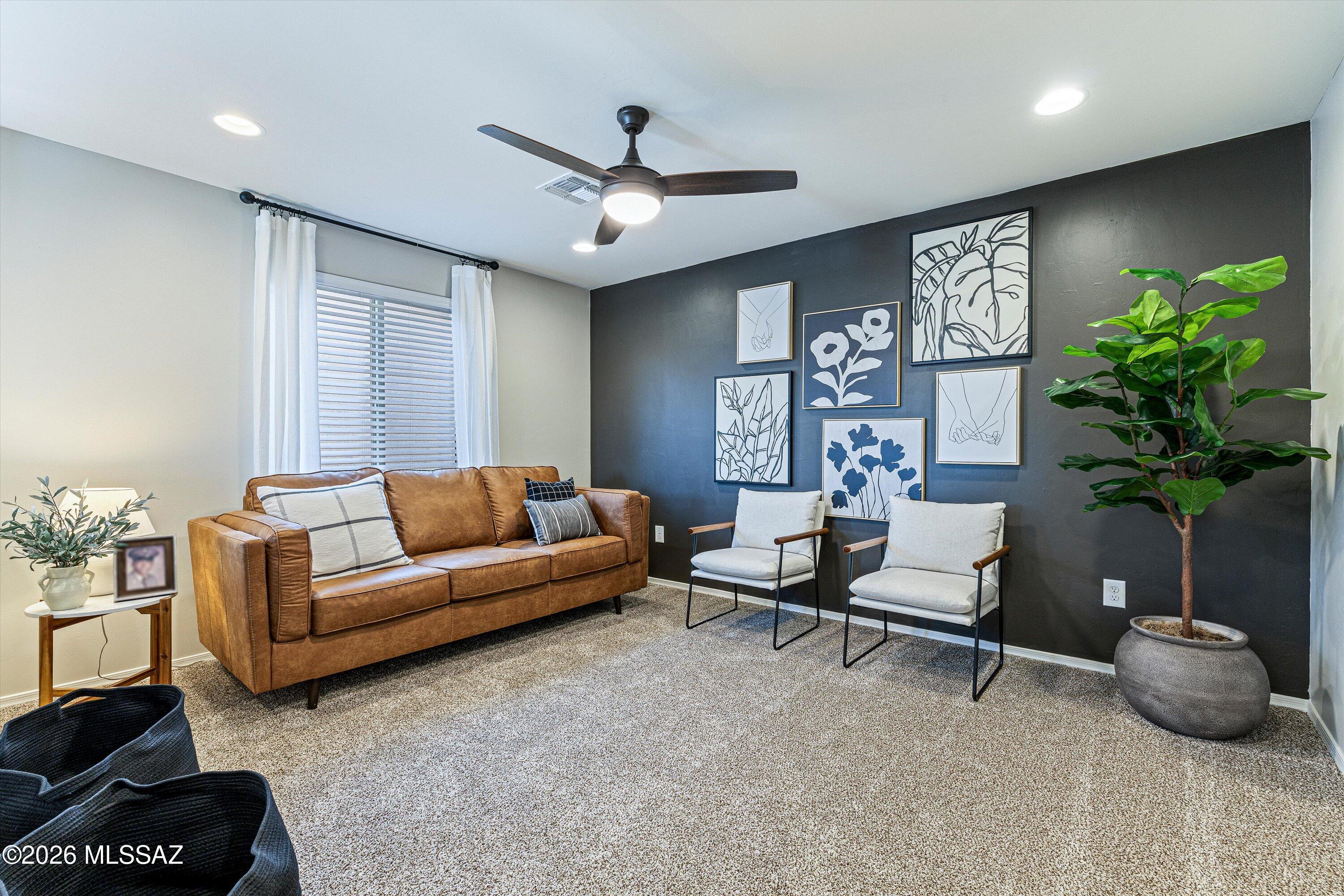 Welcome to this remarkable home in Entrada Del Pueblo, one of Rancho Sahuarita's newest and most desirable neighborhoods. Ideally located near the community's newest amenities, you'll enjoy easy access to open green space, the second community dog park, cornhole area, chess tables, multiple playgrounds, the community lake, fitness center, restaurants, shopping, and the highly anticipated new clubhouse area.
From the moment you arrive, the curb appeal and welcoming presence set the tone for what awaits inside. Thoughtfully designed and impeccably maintained, this home offers an elevated living experience with upgraded paint, designer finishes, refined details, and a beautifully enhanced stair railing that adds both character and sophistication. Every space has been carefully curated to create a warm, inviting atmosphere that feels both stylish and comfortable.
The main level features a bright and open floorplan centered around a striking electric fireplace and custom feature wall that create an impressive focal point for everyday living and entertaining. The glass-door office provides excellent flexibility and can easily function as a fourth bedroom, with space already available for a future closet addition.
The kitchen blends beauty and functionality with rich espresso cabinetry, brushed gold hardware, a designer backsplash, black sink, ample storage, and an open layout that flows seamlessly into the living and dining spaces.

Upstairs, a spacious loft offers additional living space perfect for a media room, play area, home gym, or second family room. Three generously sized bedrooms, a conveniently located laundry room, and additional storage complete the upper level.

One of the home's most valuable features is the professionally landscaped backyard, offering a move-in ready outdoor retreat while saving thousands in landscaping expenses. Designed for both relaxation and enjoyment, the outdoor space provides the perfect setting for entertaining, unwinding, and embracing Arizona living.
Combining thoughtful design, modern upgrades, exceptional community amenities, and a location that continues to grow in popularity, this home delivers the perfect balance of style, comfort, and value. Beautifully finished and truly move-in ready, this is a home that feels elevated, welcoming, and ready for its next chapter.
