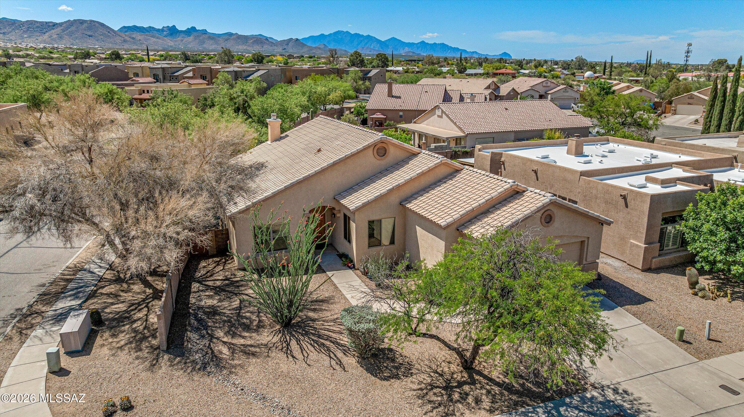 Located in the award-winning Vail School District, this contemporary Spanish home is ready for you. Offering two bedrooms, two bathrooms plus den in 1,845 sq.ft., there's plenty of space to live in and grow for years and years to come. Situated on a large, desirable corner lot in a small subdivision of just 50 homes, you'll really enjoy the peace and quiet that this community and Vail have to offer. Enter from the covered entry into a small foyer that transitions into the large great room, framing the gorgeous gas beehive fireplace for Southern Arizona's bone chilly nights. The kitchen and dinette have a framed view of the great room and oversized sliding glass door that look into the backyard. All appliances convey. With a split bedroom floor plan, you'll be separate from your little ones or guests. The primary bedroom offers vaulted ceilings, another oversized slider, dual vanity, shower/tub combo, and closet space galore. Across the home are the hallway lined with cabinetry, the secondary bathroom, and secondary bedroom. The den/office is an excellent bonus room and is the perfect space for a third bedroom conversion, or simply adding a Murphy bed that stays out of the way when you don't need the sleeping accommodations! The large backyard with mature desert landscaping, including citrus, is perfect for winding down after a long day. With a south-facing backyard, the afternoon summer sun will not be a worry. Other highlights for the home include a large laundry room for additional storage as well as an extended-length 2-car garage for the larger vehicles or more storage! Affordable HOA averages to $45/month to keep the neighborhood tidy. Vail is an actively growing city with incredible schools and plenty of shopping/dining, easy access to the Pima County Fairgrounds, Sahuarita, and I-10. Come, see, and stay - you won't regret it!