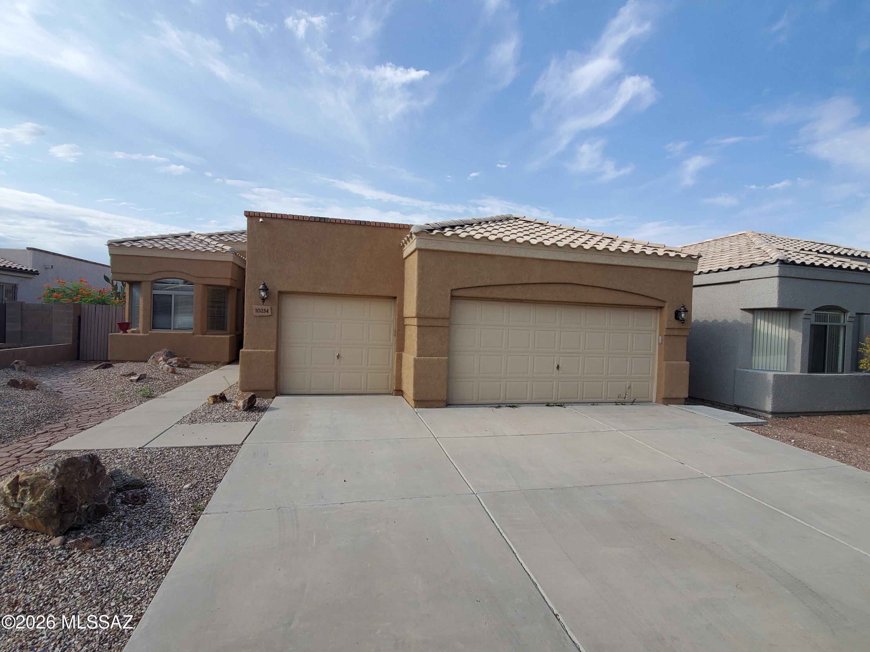 Beautifully Remodeled 4-Bedroom, 2 bath home with Pool & Spa in Pueblo Estrella at Rita Ranch. This exceptional home features a spacious great room, upgraded lighting, ceiling fans, and hard-surface flooring with no carpet throughout. The inviting kitchen offers ample cabinetry, breakfast bar, &  charming bay window that fills the breakfast nook with natural light. Retreat to the spacious primary suite, complete w/private patio access, large walk-in closet, & luxurious en-suite bathroom featuring dual vanities & custom walk-in shower. Step outside to your own backyard oasis, designed for entertaining and relaxation. Enjoy the extended covered tile patio, fully equipped outdoor kitchen, sparkling swimming pool, and spa. Conveniently located within the highly acclaimed Vail School District.